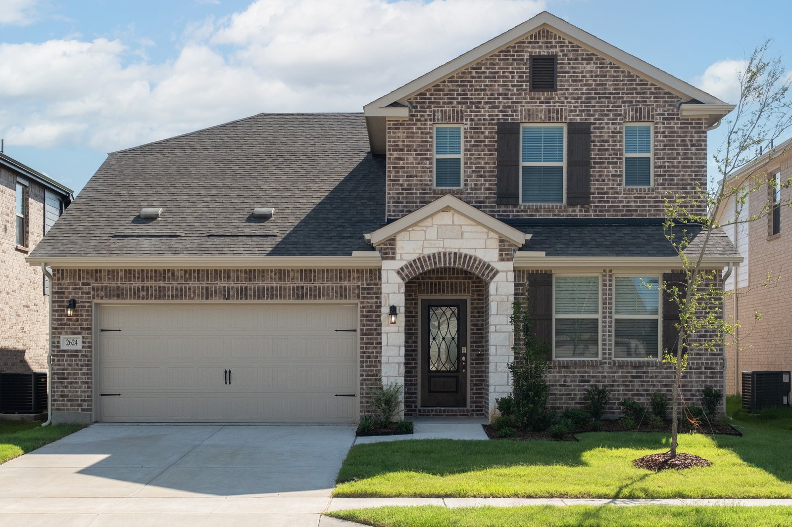 two-story home with brick and stone exterior