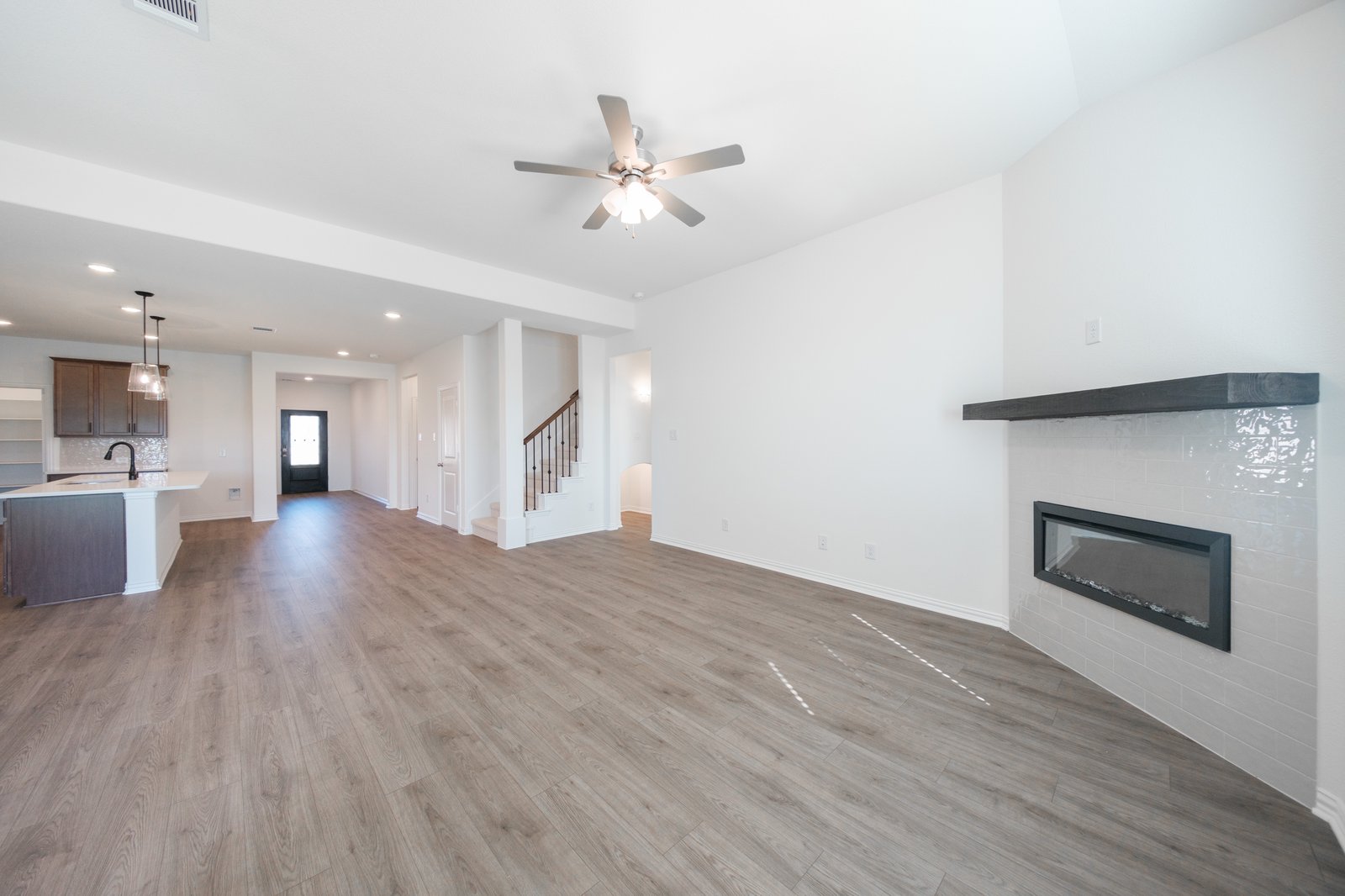 open great room with wood floors and fireplace