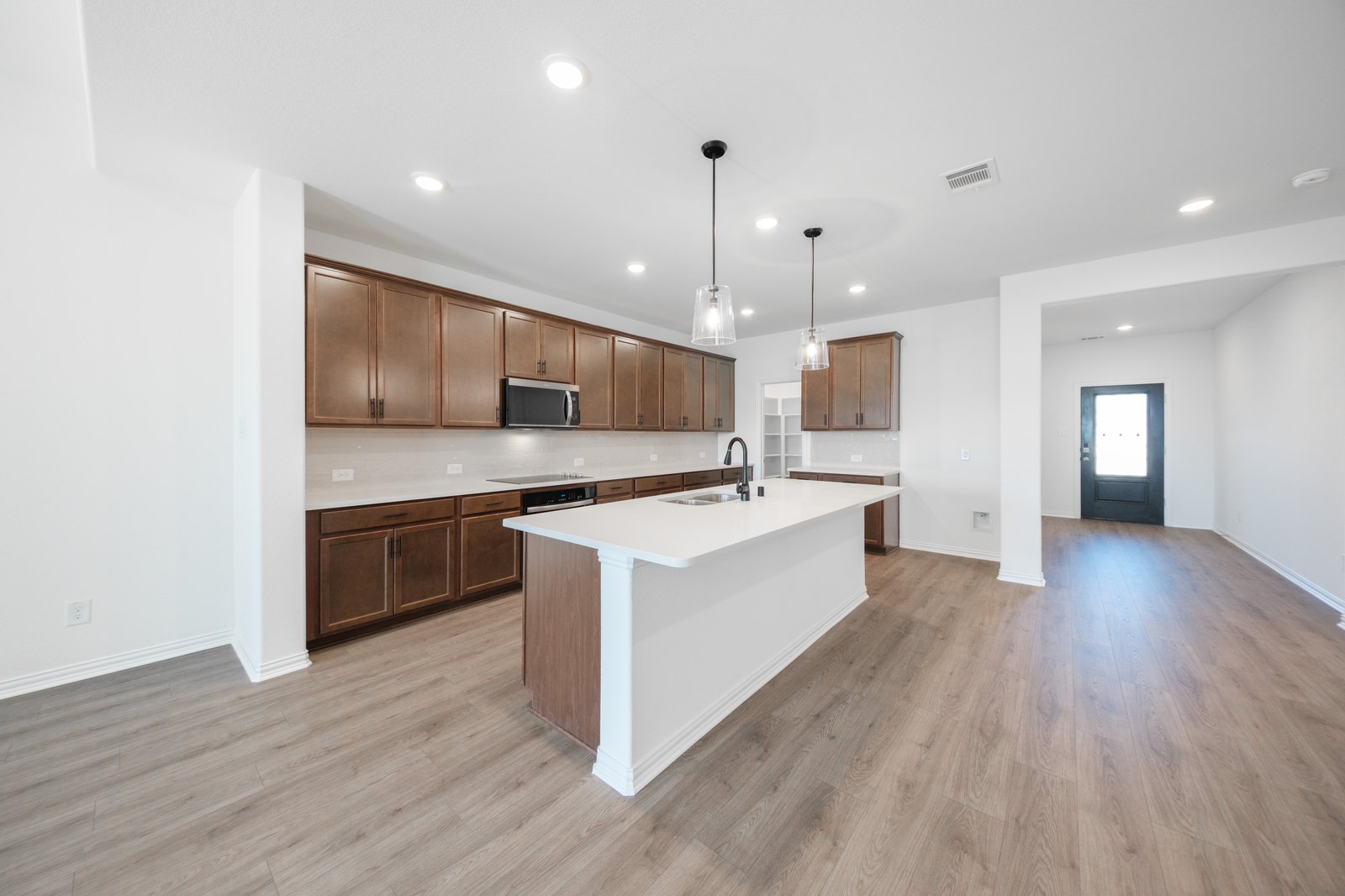 open kitchen with wood floors and island