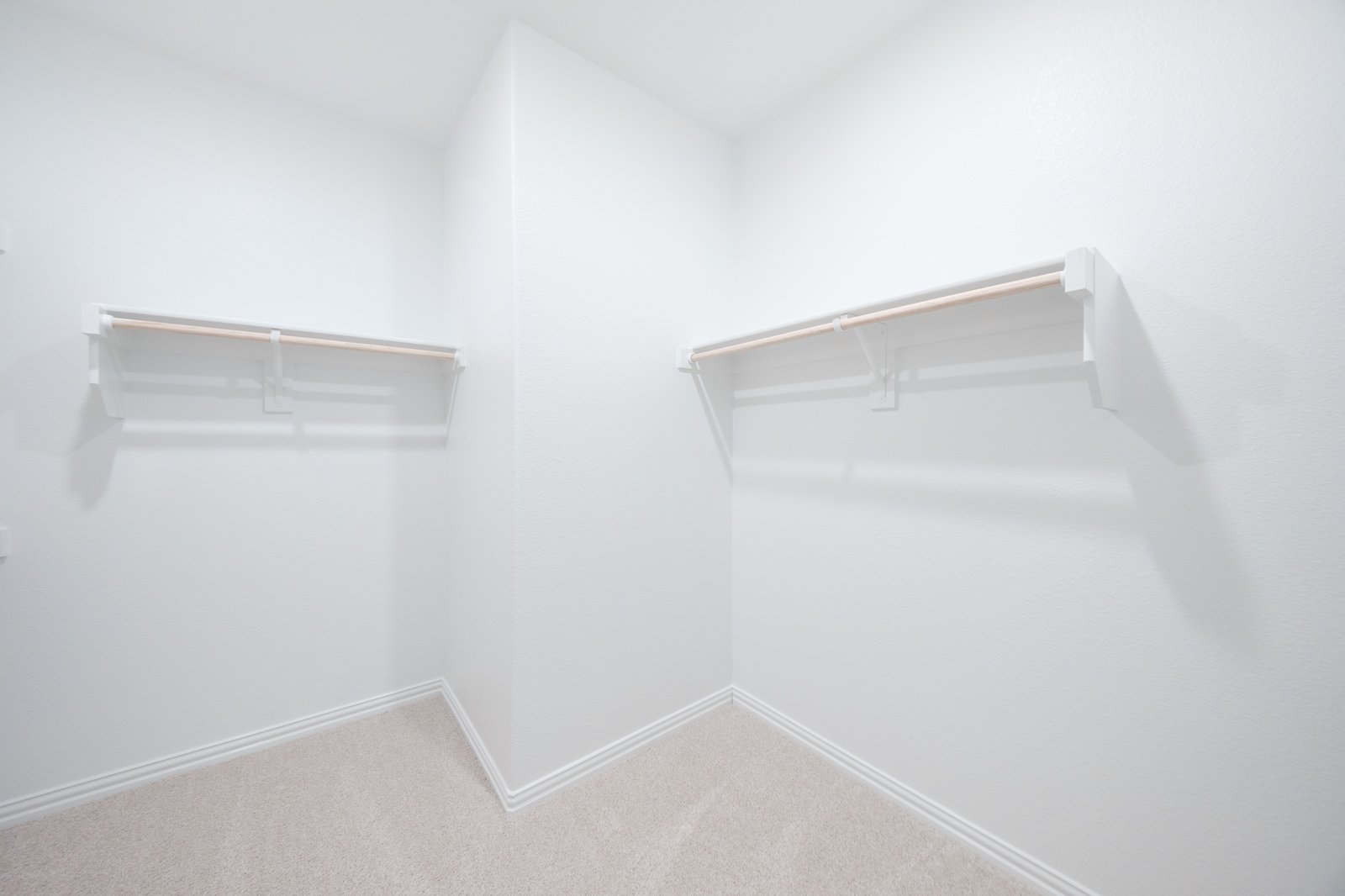 primary bedroom closet with carpet and white shelves