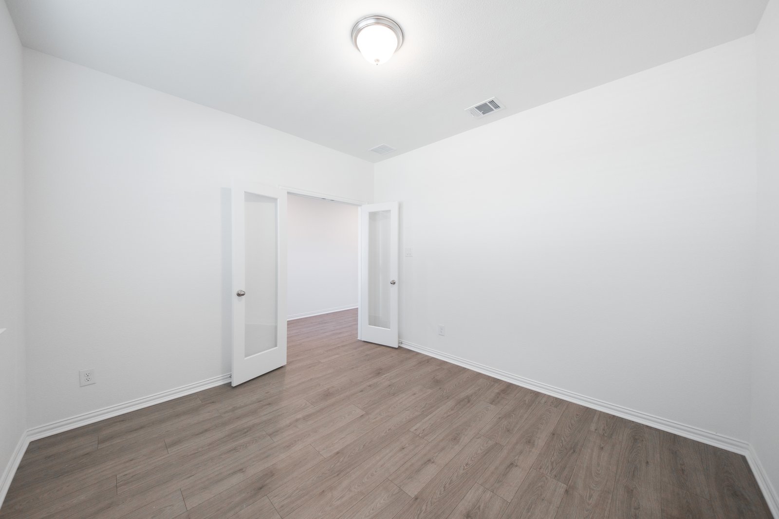 private study with wood floors and windows