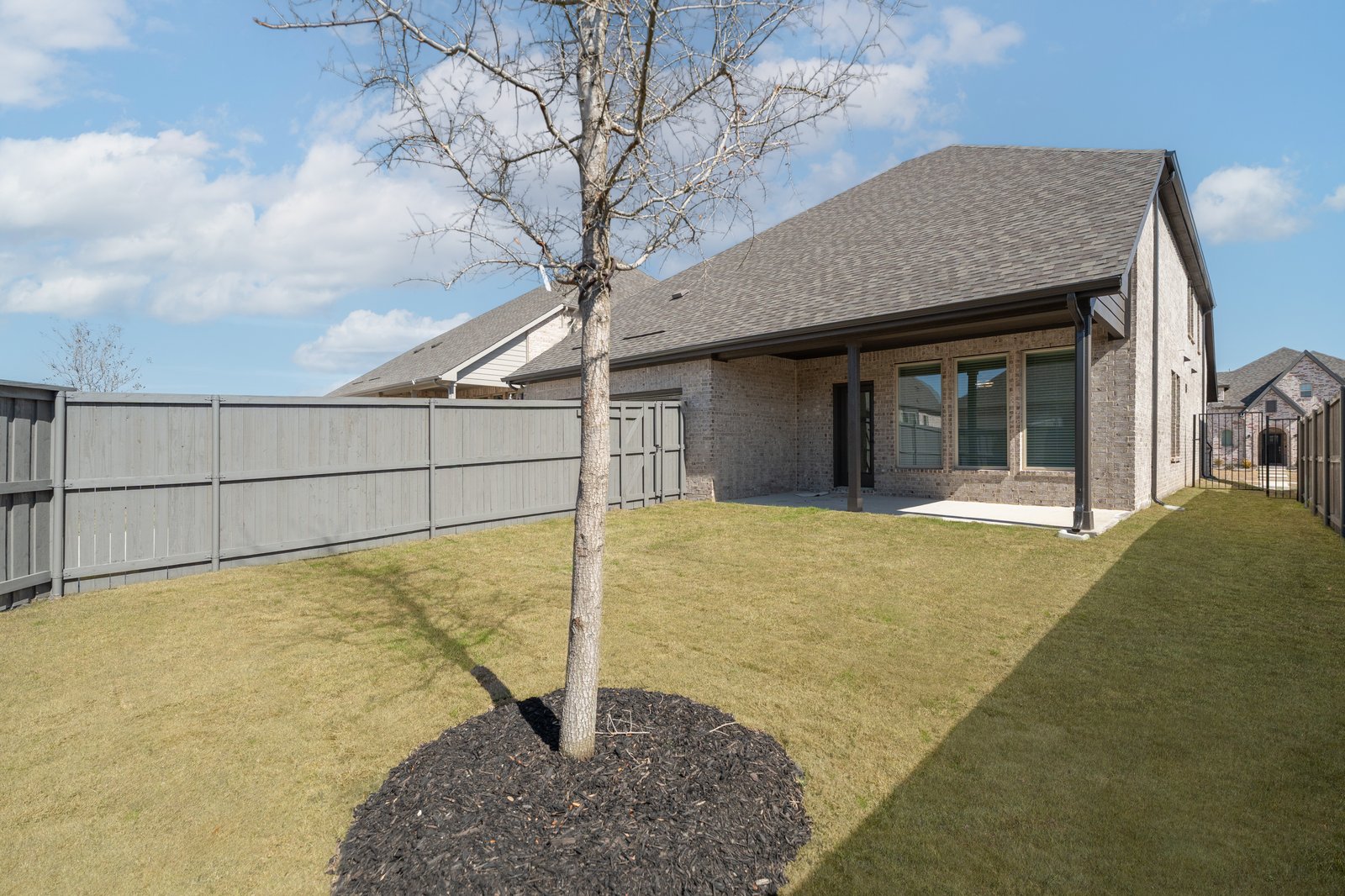 backyard with grass and covered patio
