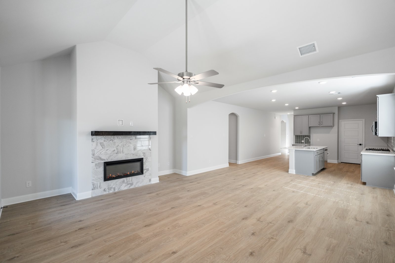 open great room with wood floors and fireplace