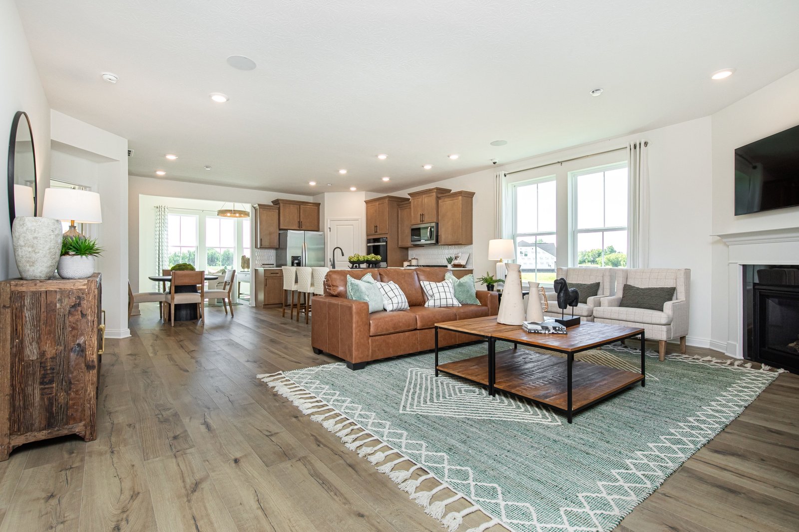 great room with wood plank flooring and tan couch