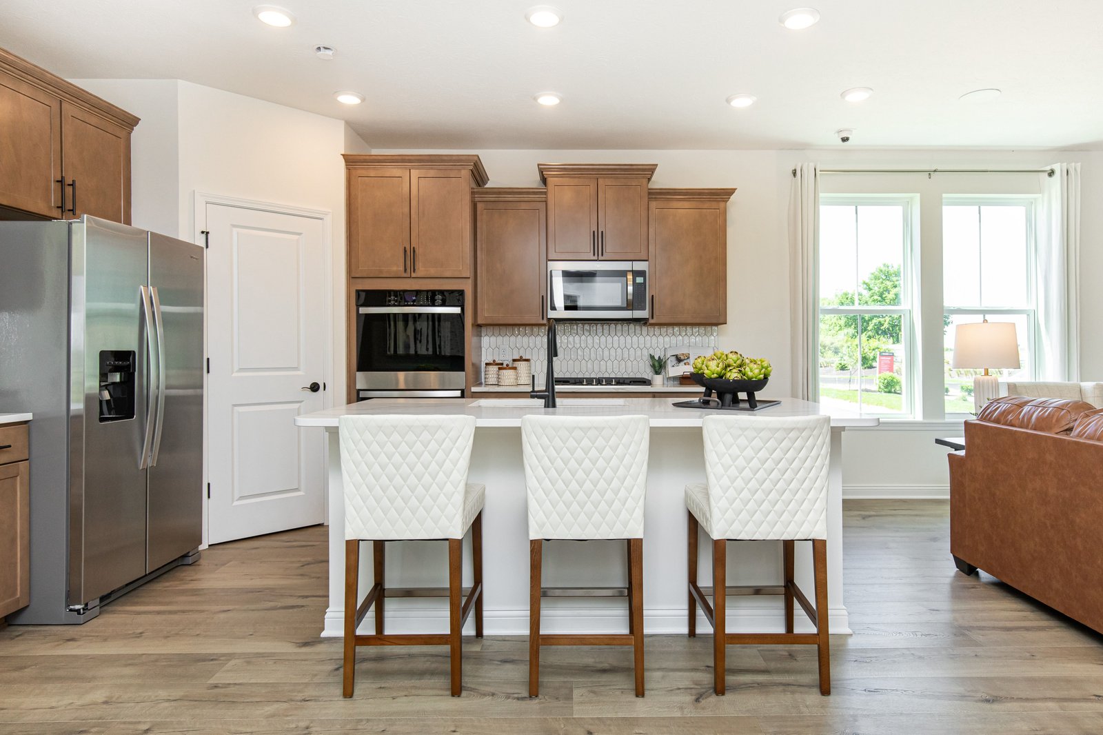kitchen with tan wood cabinets and white counter tops