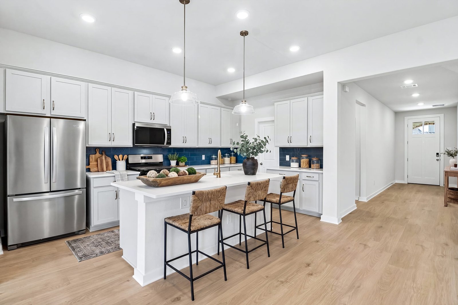 kitchen with brown flooring, quartz countertops and pendant lighting