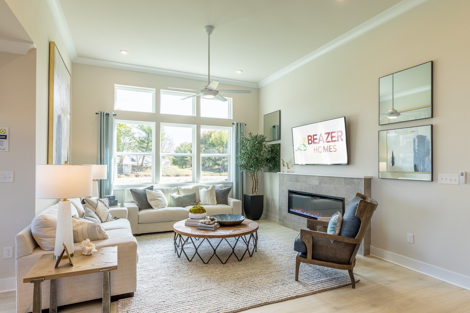 great room with couches and a fireplace