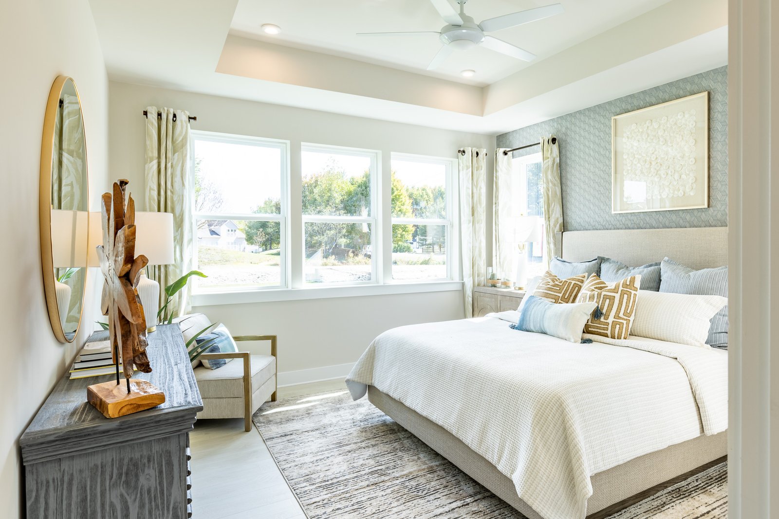 primary suite with a box ceiling and carpet