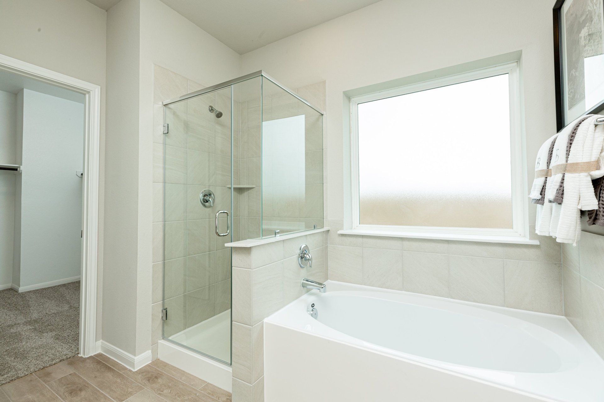 bathroom with white tub and walk-in shower