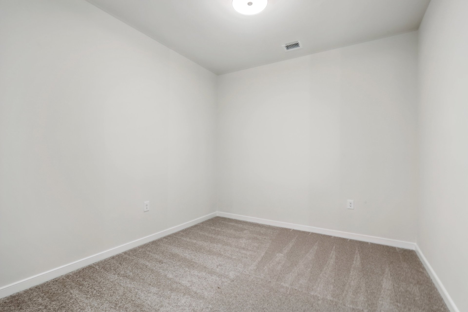 office with carpet and overhead light