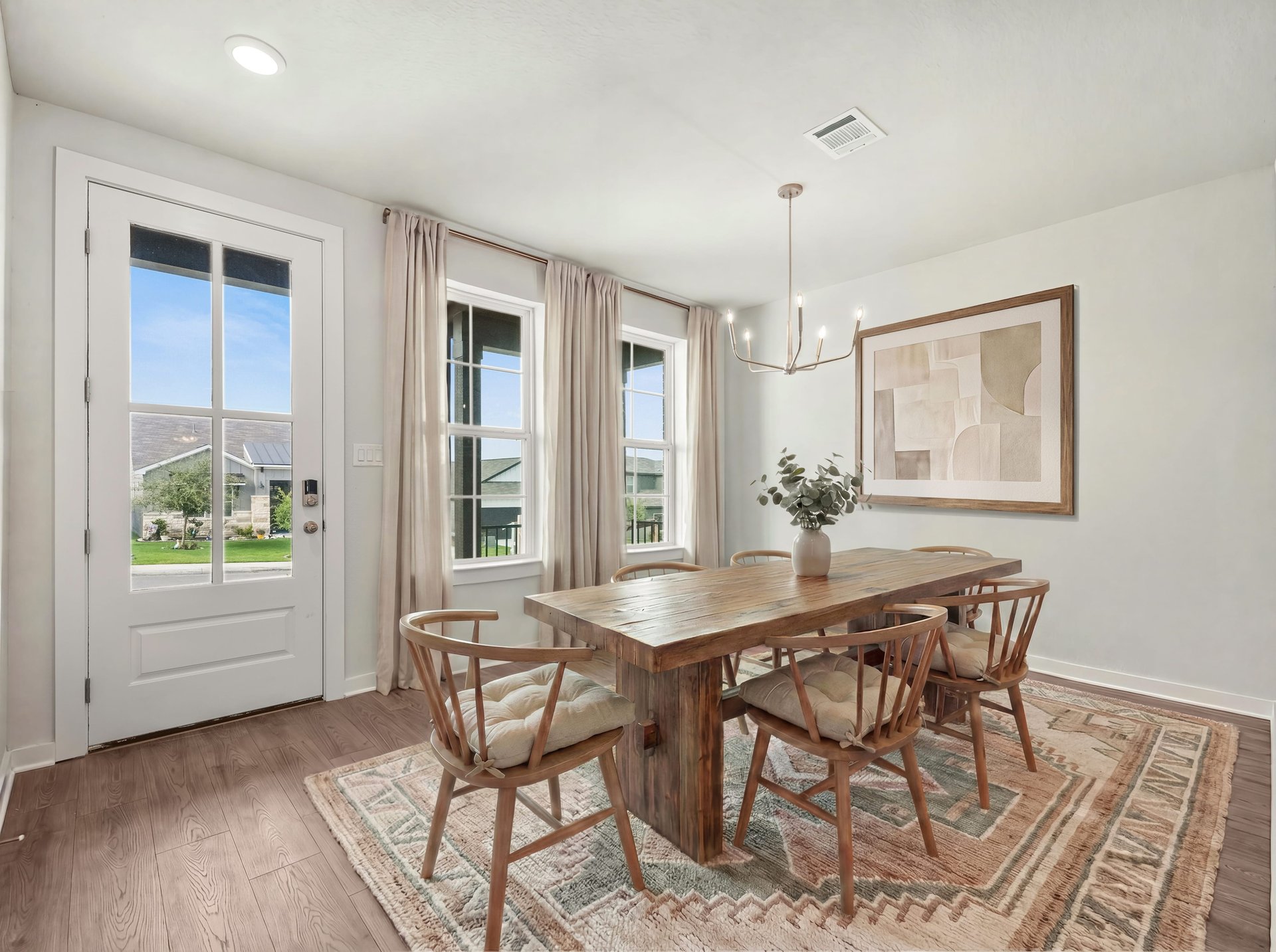 dining area with window, ceiling lighting, and brown flooring