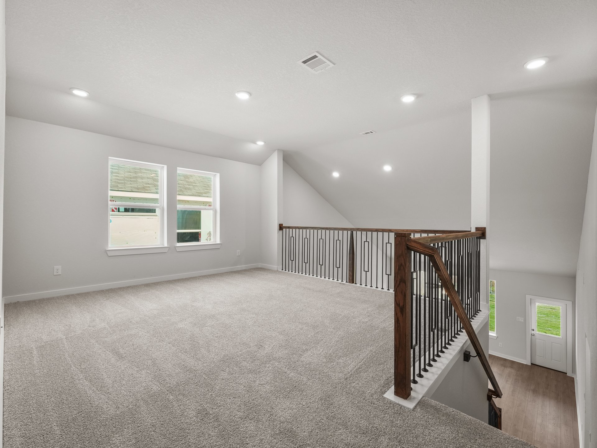 loft with carpet, staircase and windows