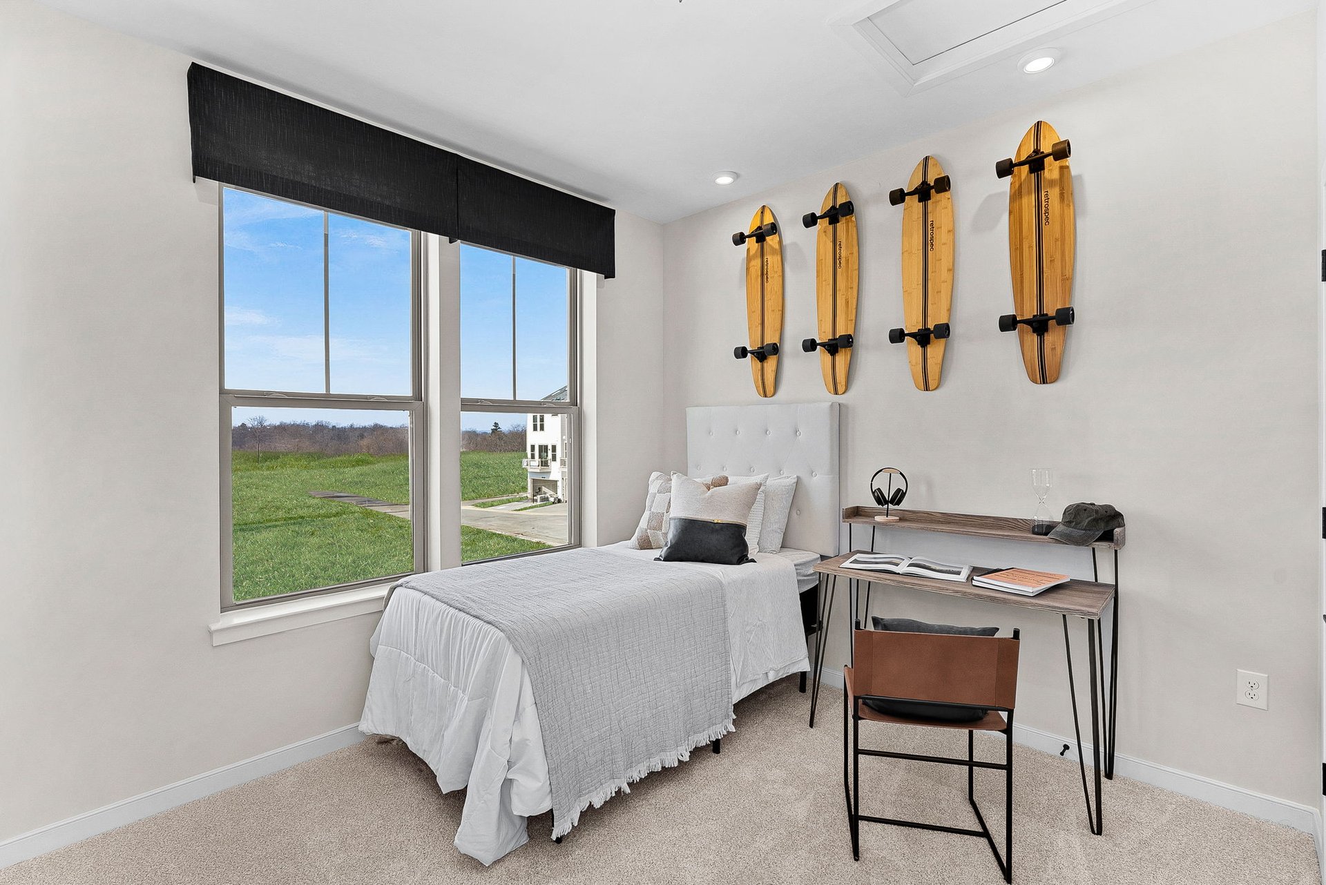 secondary bedroom with a desk and two windows