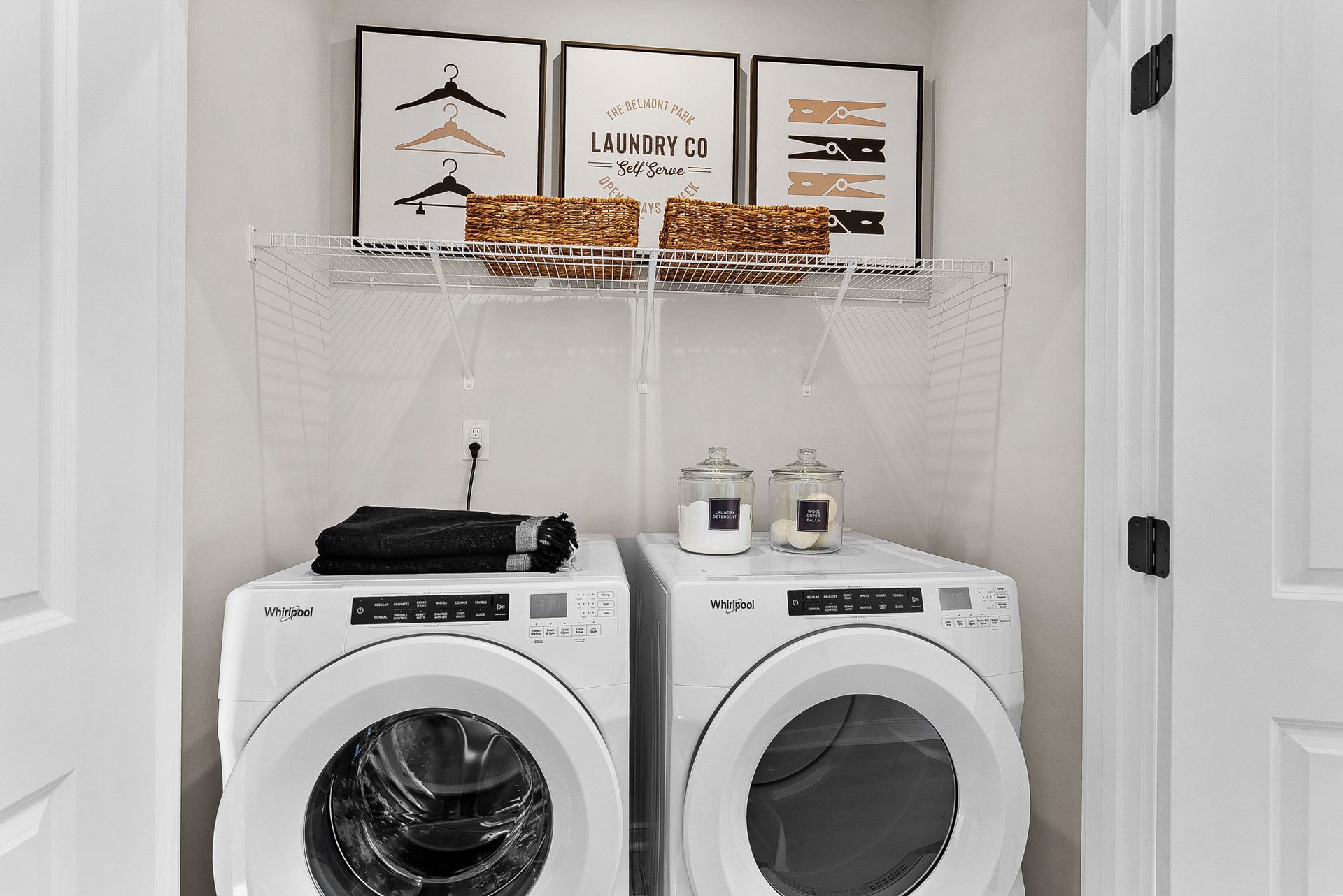 laundry room with a washer & dryer and a wire shelf