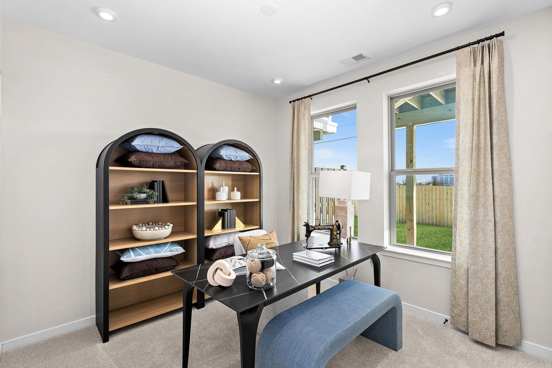 secondary bedroom as an office with a desk and two windows