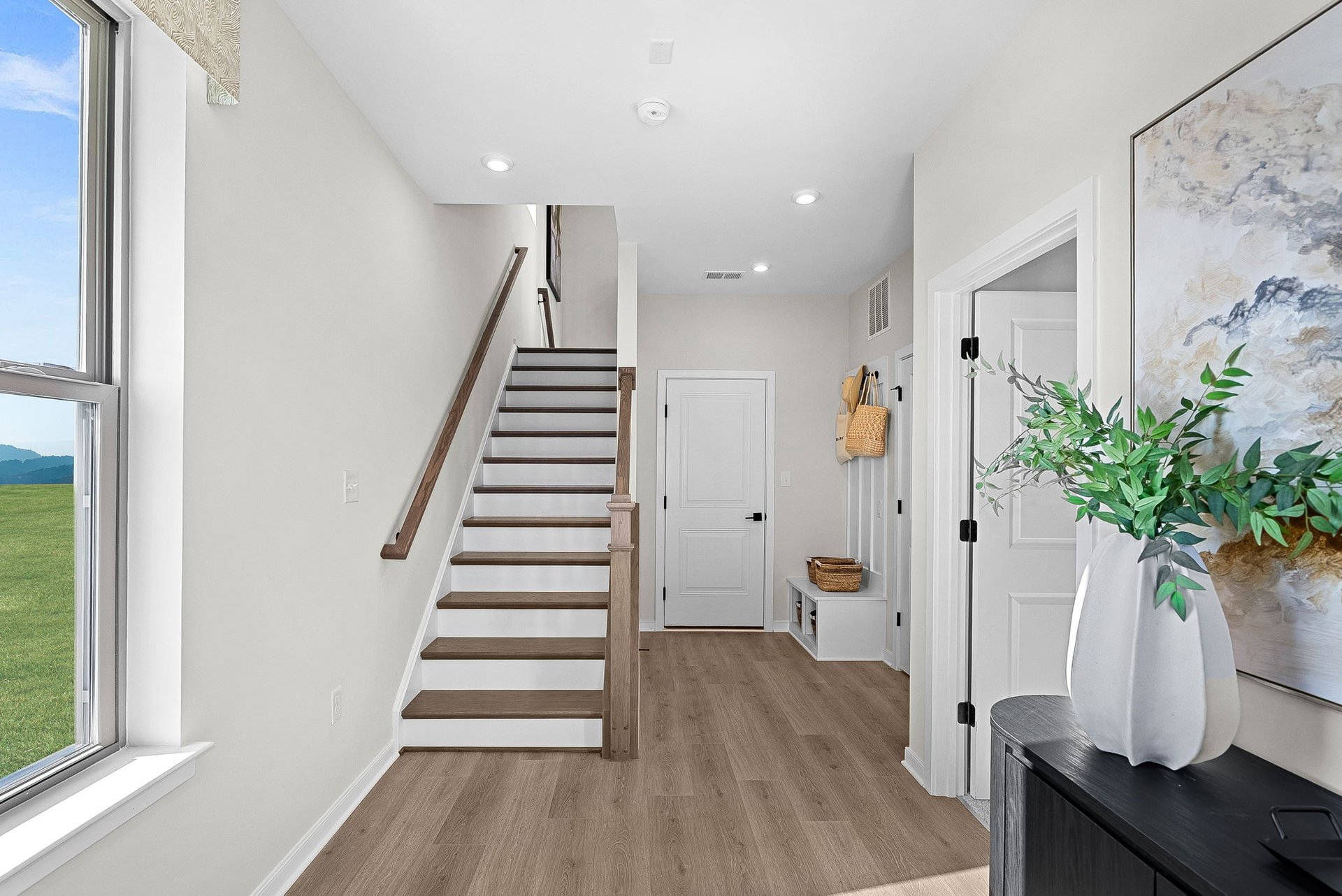 foyer with a mudroom bench with hooks and cubbies