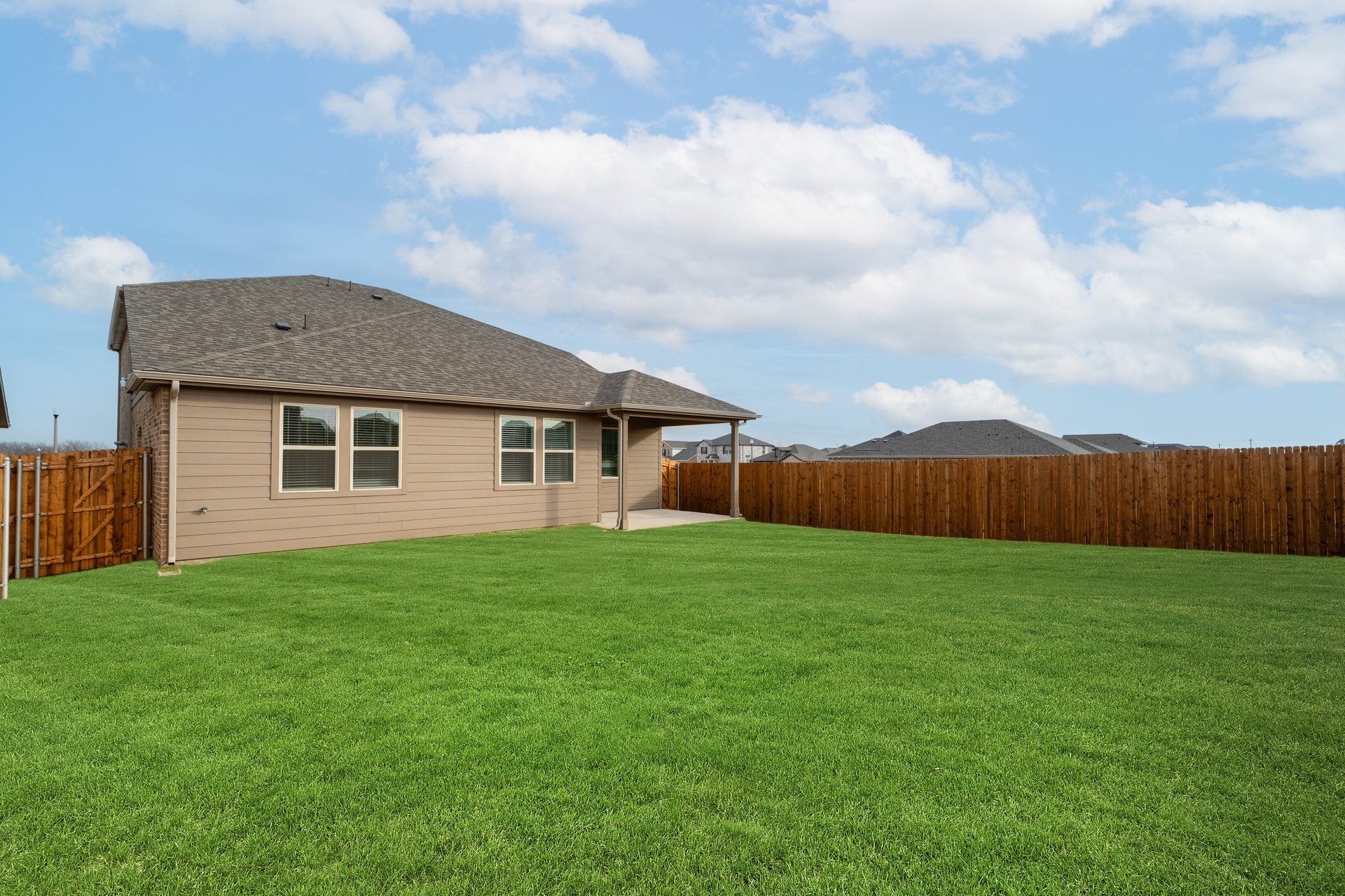 backyard with grass and covered patio
