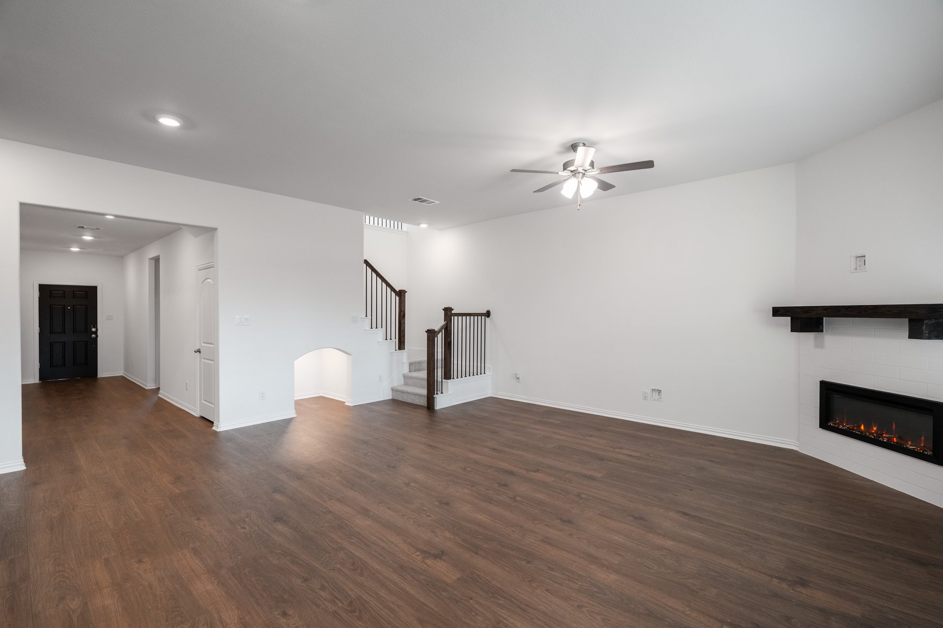 open great room with wood floors and fireplace