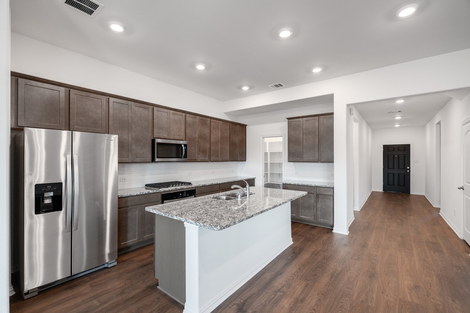 open kitchen with wood floors and island