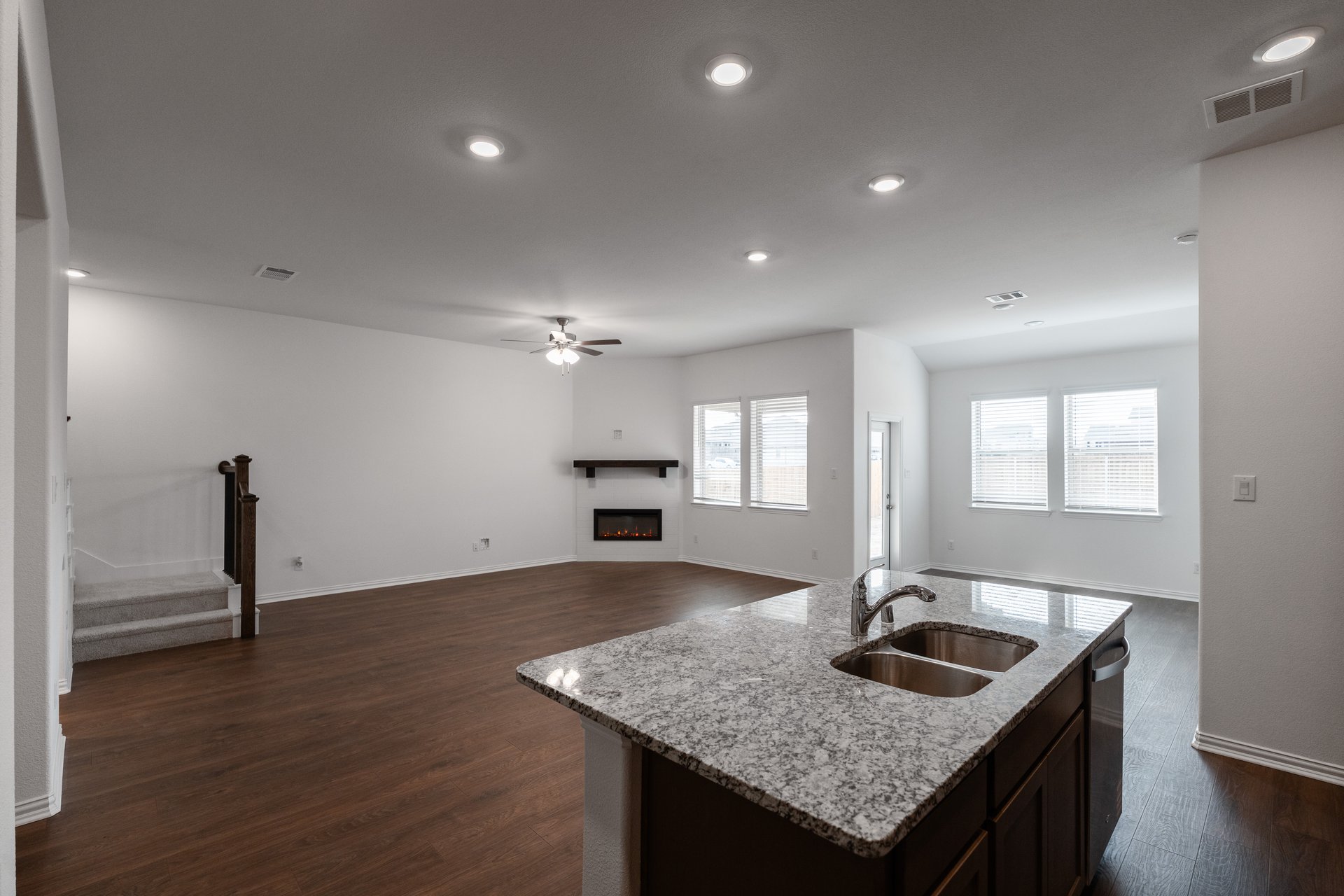 open kitchen with wood floors and island