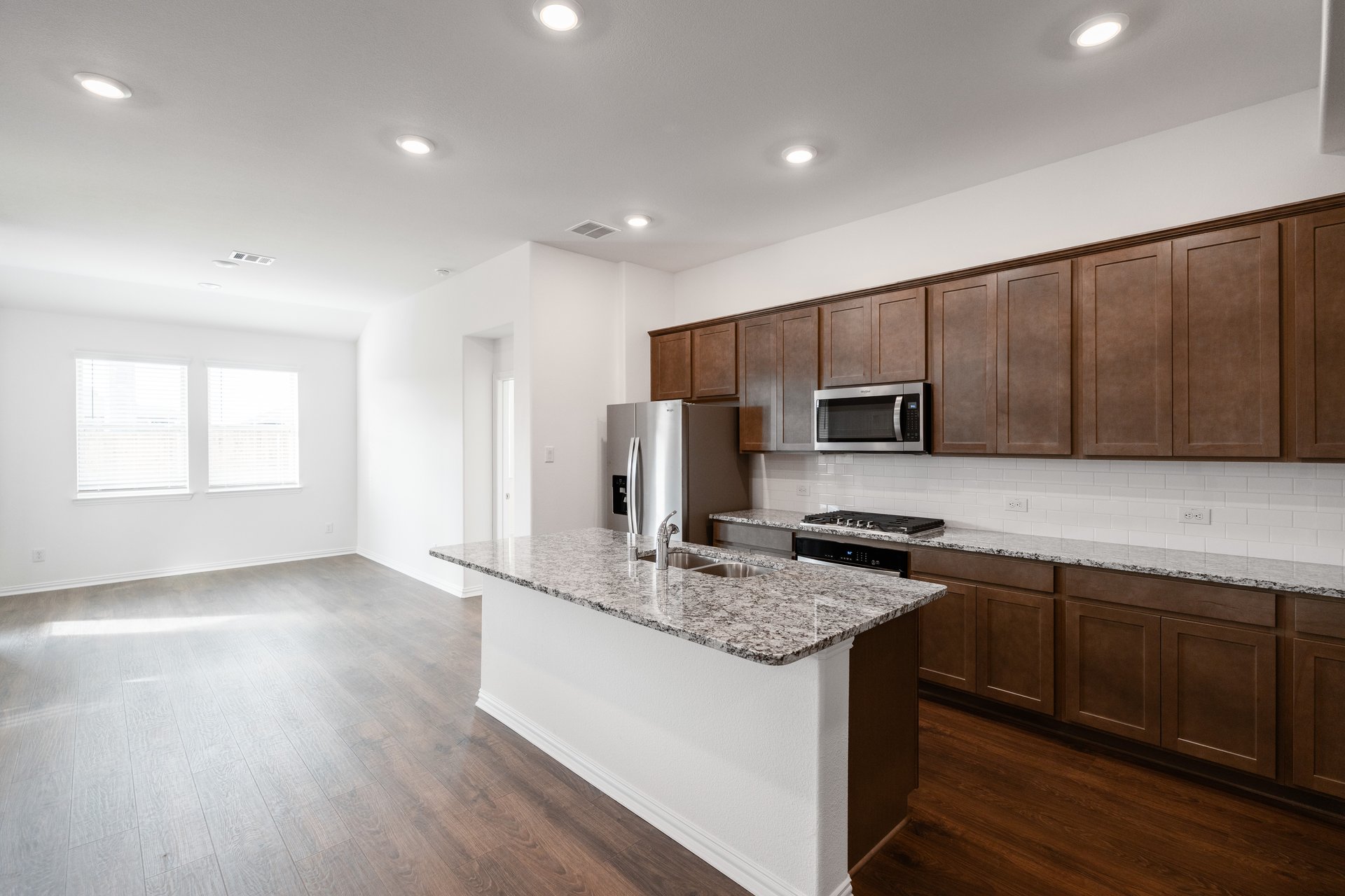 open kitchen with wood floors and island