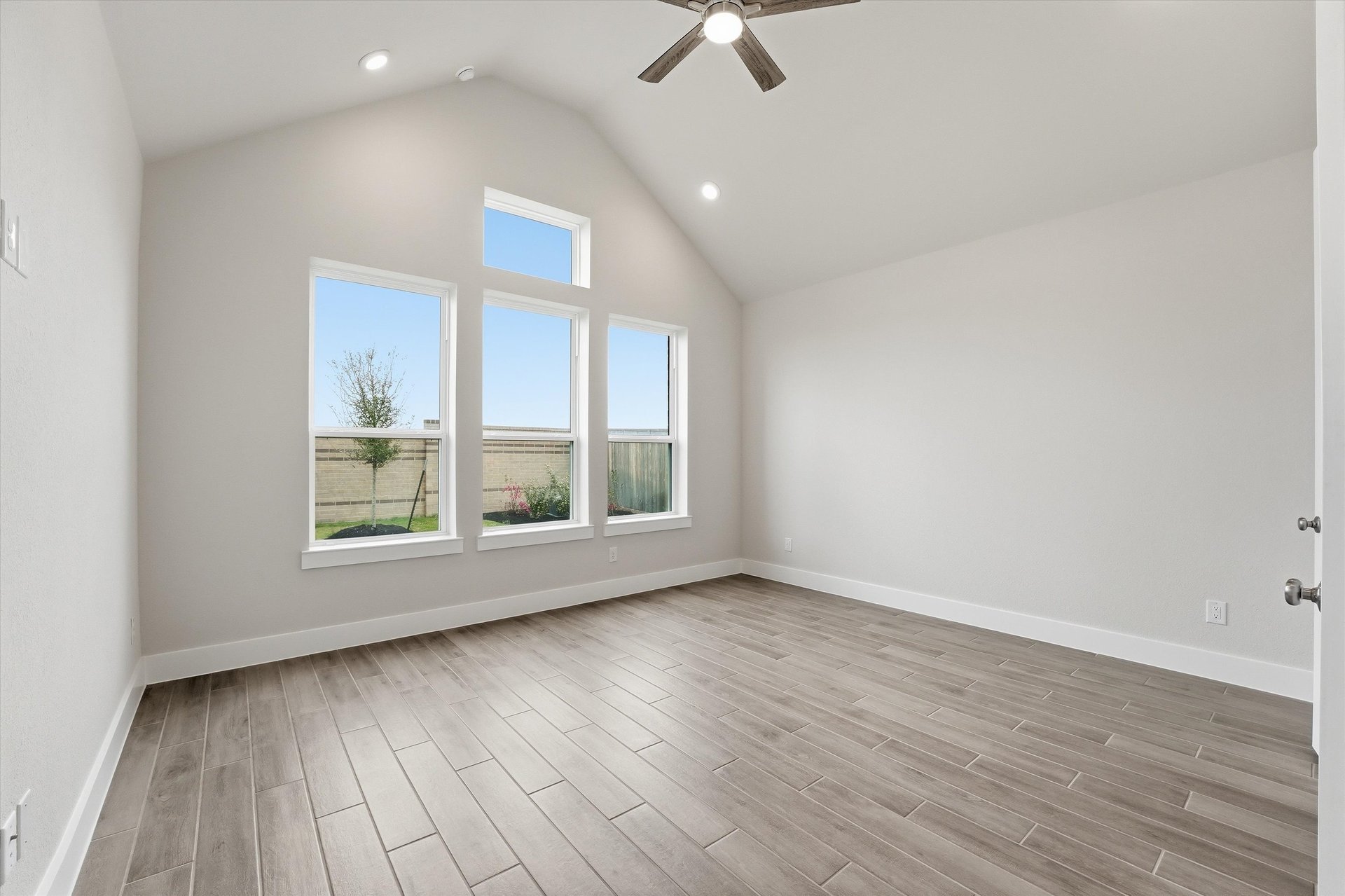primary bedroom with vaulted ceilings