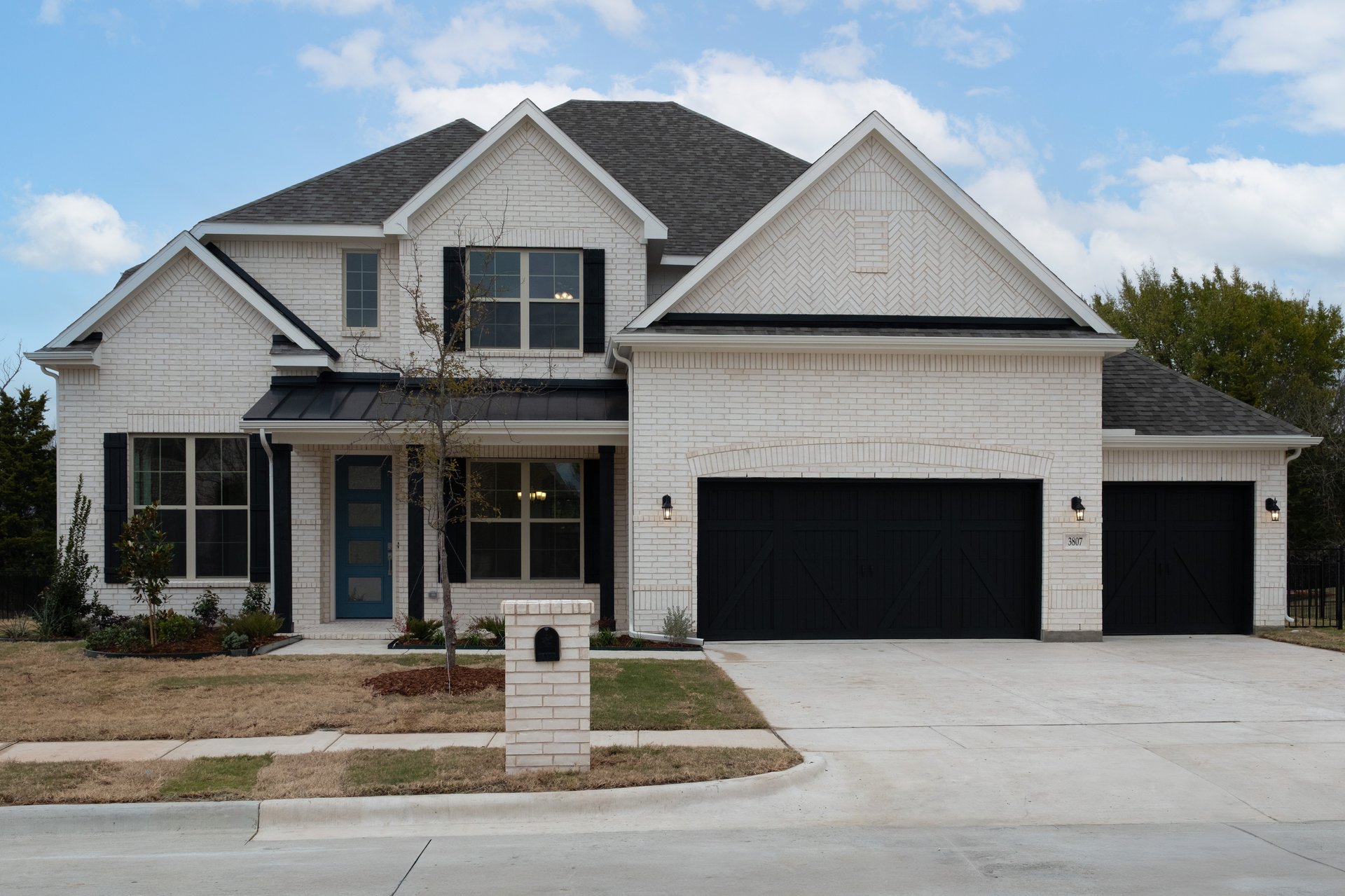 two-story home with brick and shutters