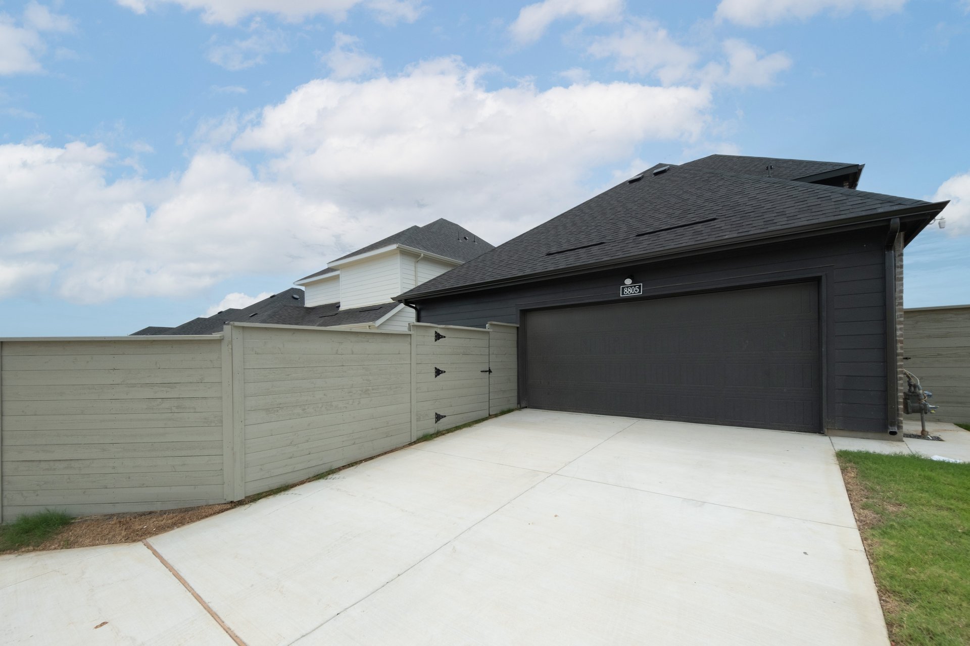view of black garage from alleyway
