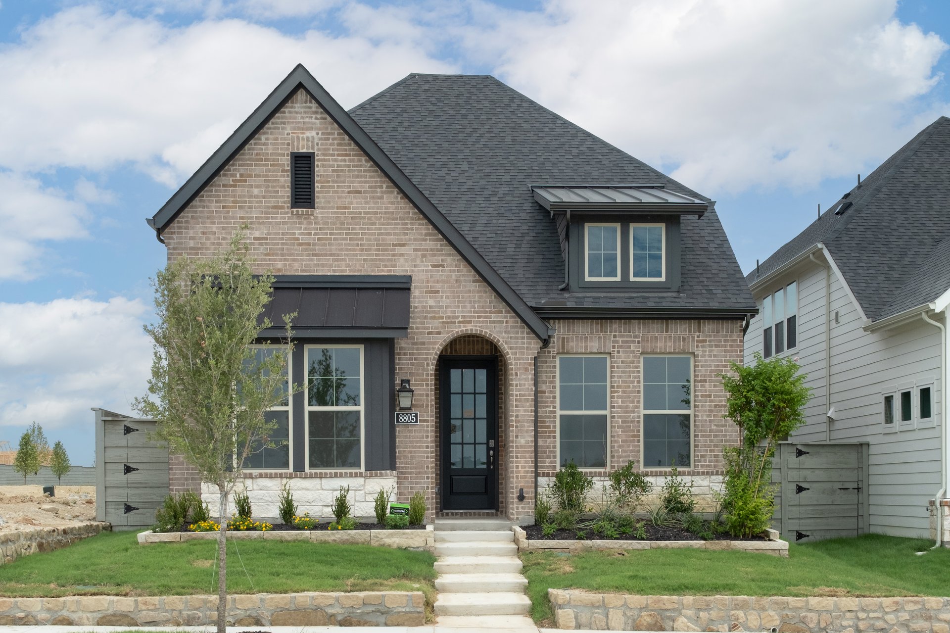 exterior of home with brown brick and black accents
