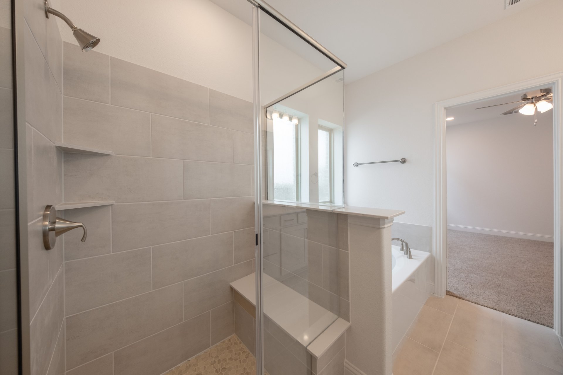 primary bathroom with separate walk-in shower and soaking tub