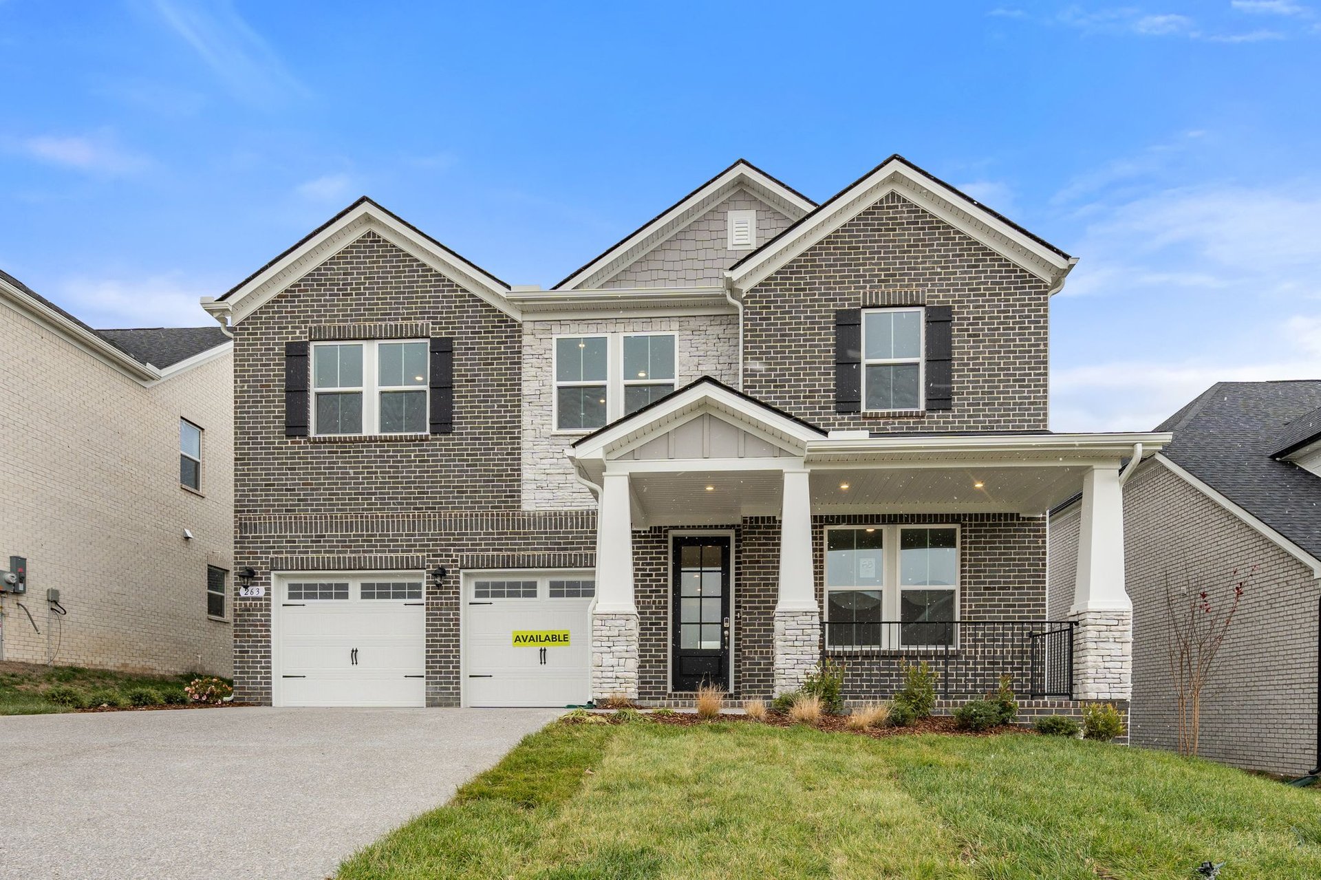 exterior with brick and covered front porch