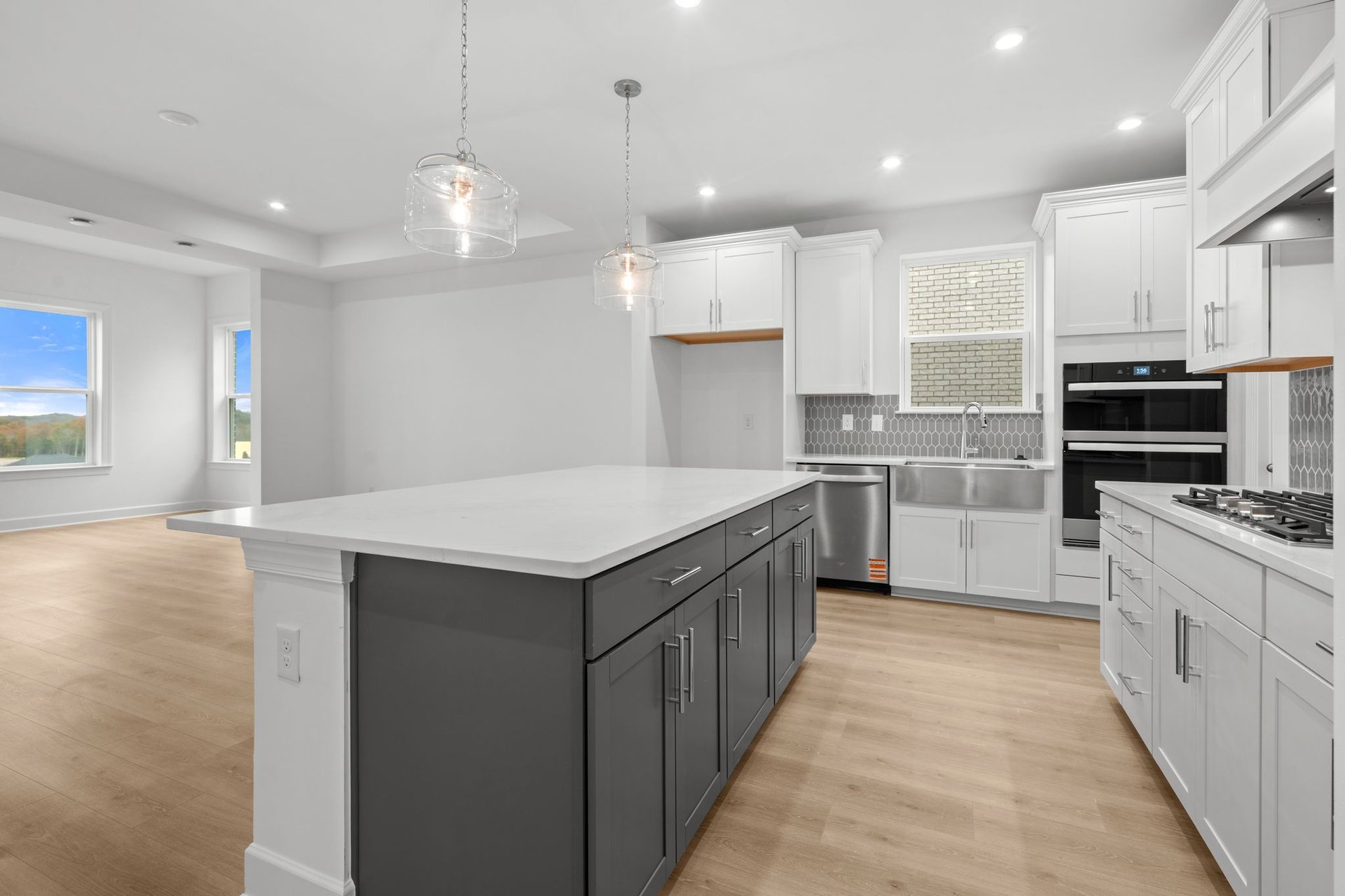 kitchen with gray island cabinets, white cabinets, and white countertops