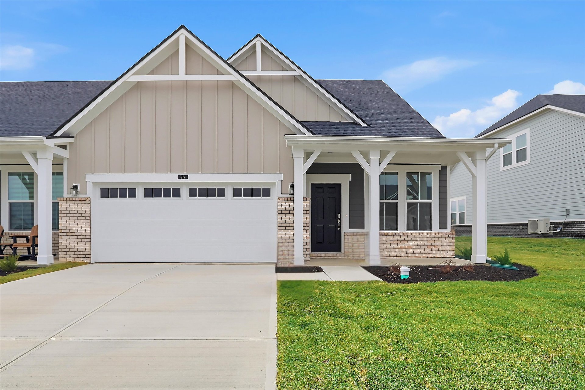 front exterior of home with tan siding and covered patio