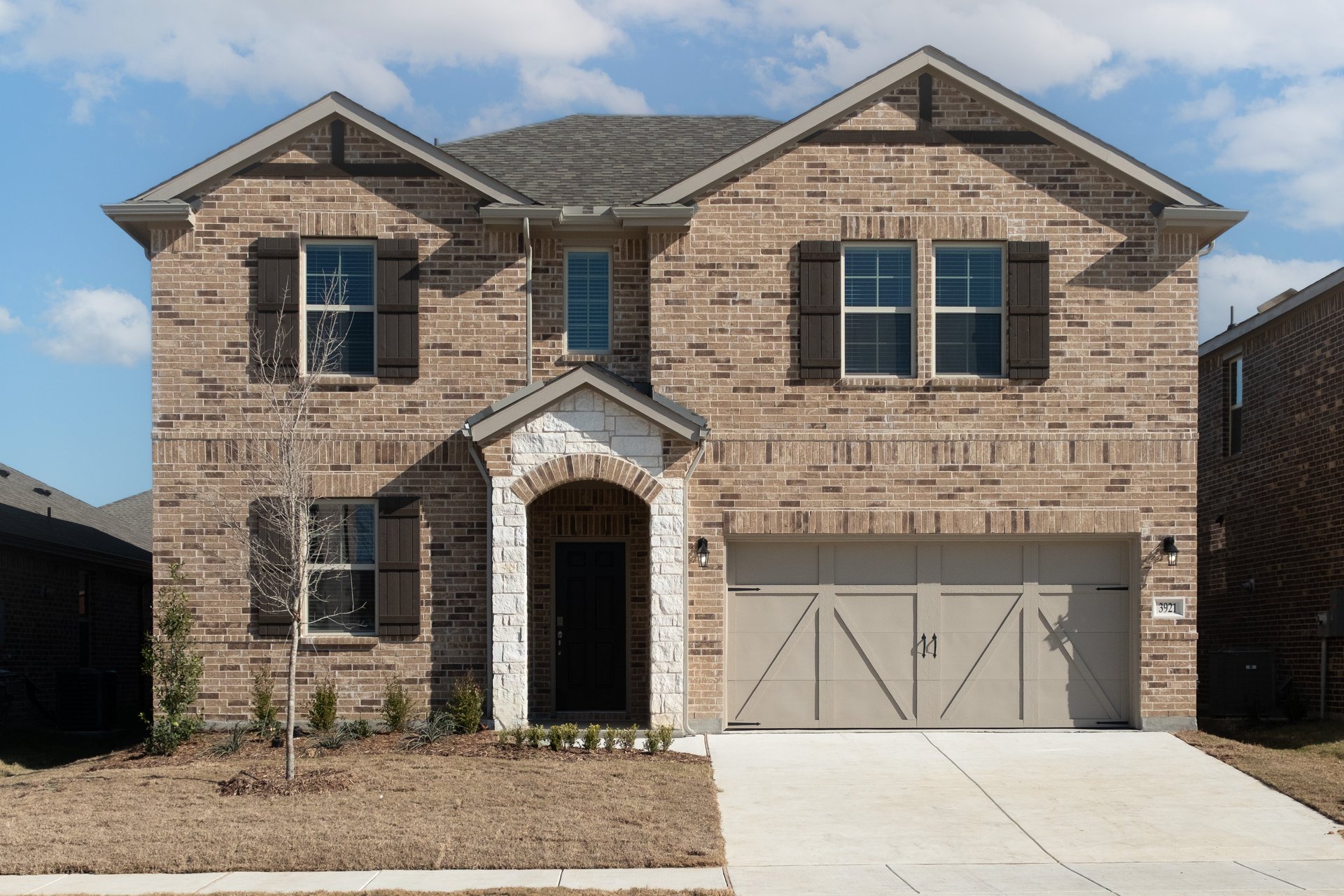 two-story home with brick and stone exterior