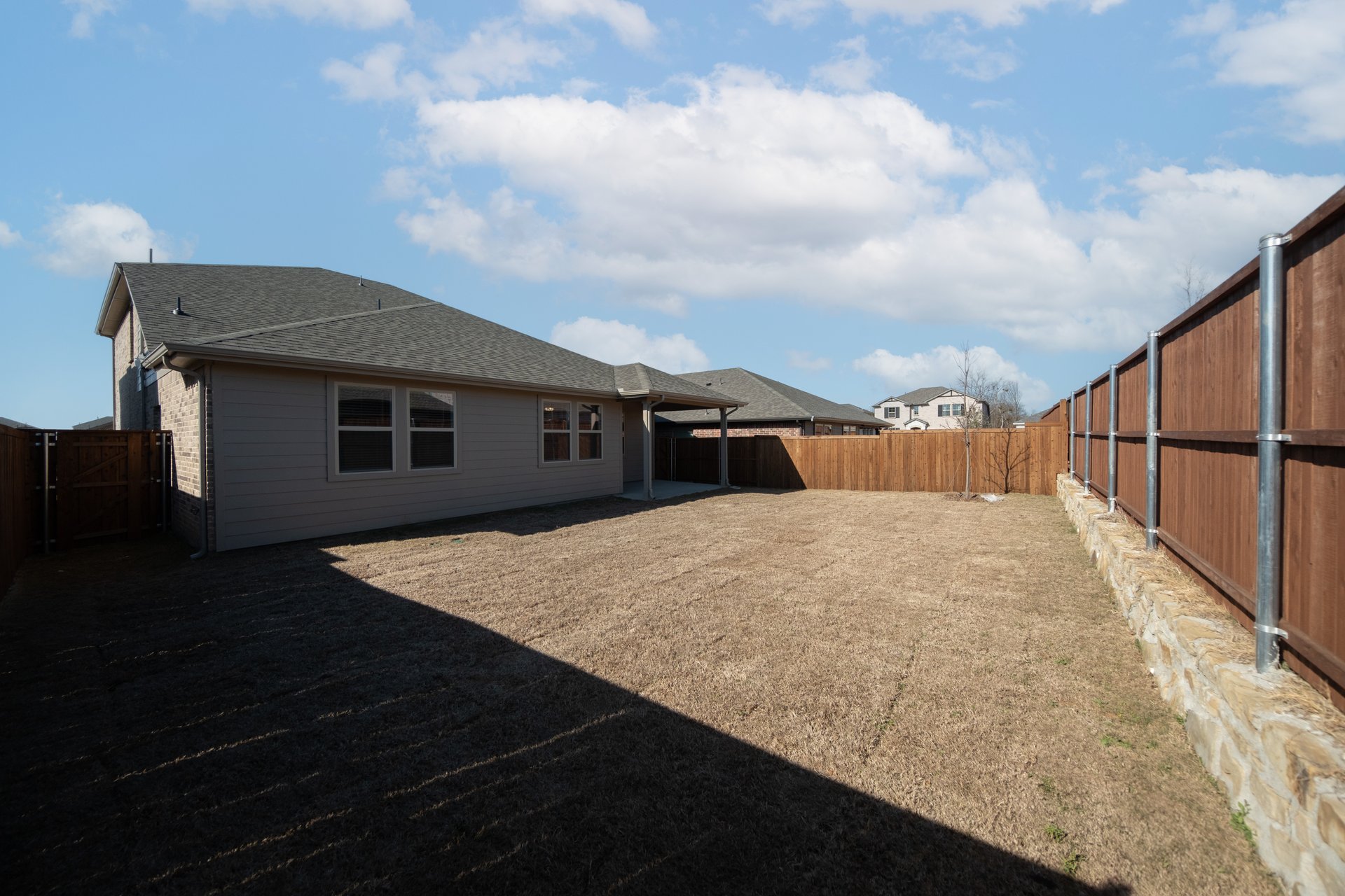 backyard with grass and covered patio