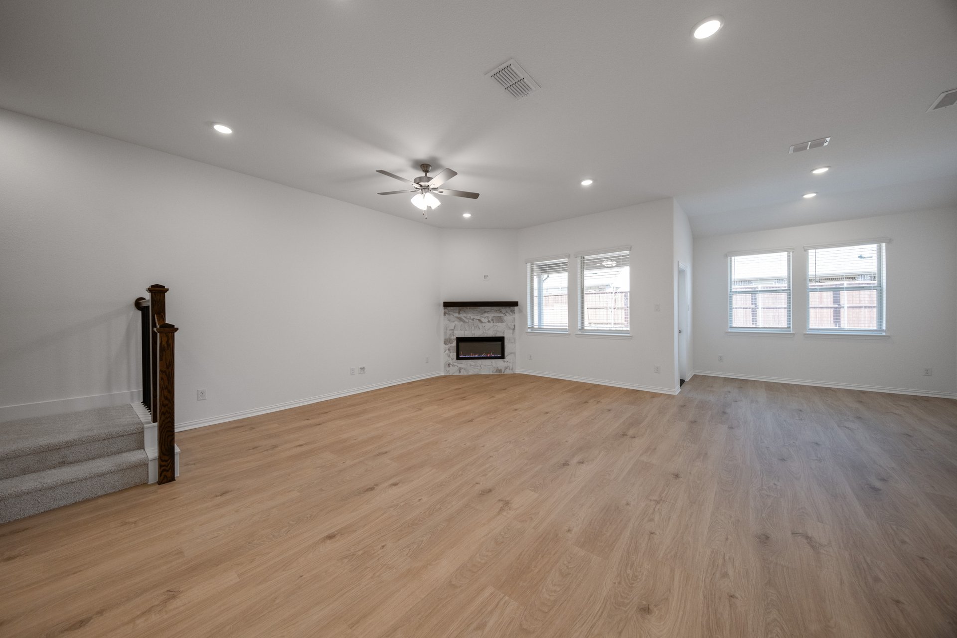 open great room with wood floors and fireplace