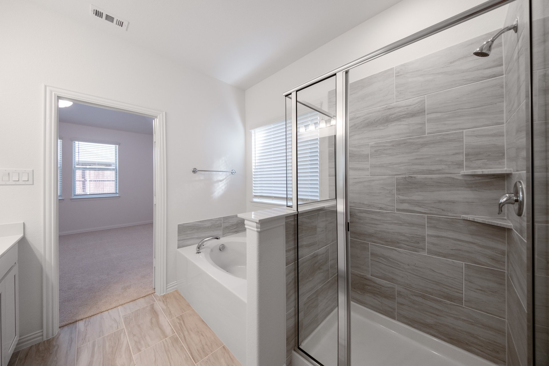 primary bathroom with soaking tub and walk-in shower