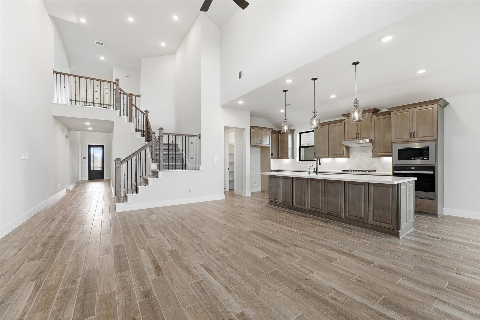 great room with two-story ceilings and staircase