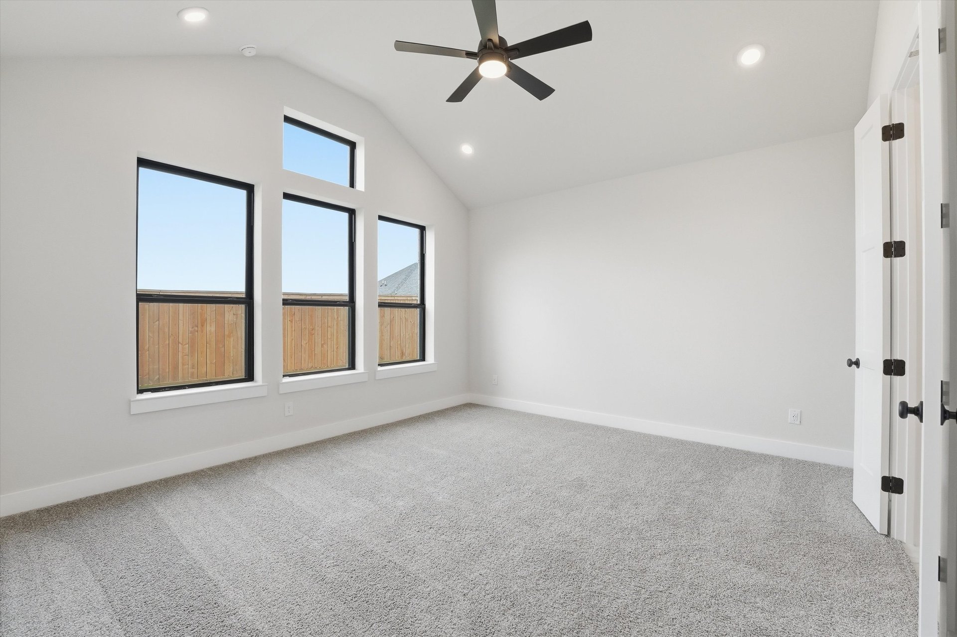 primary bedroom with vaulted ceilings