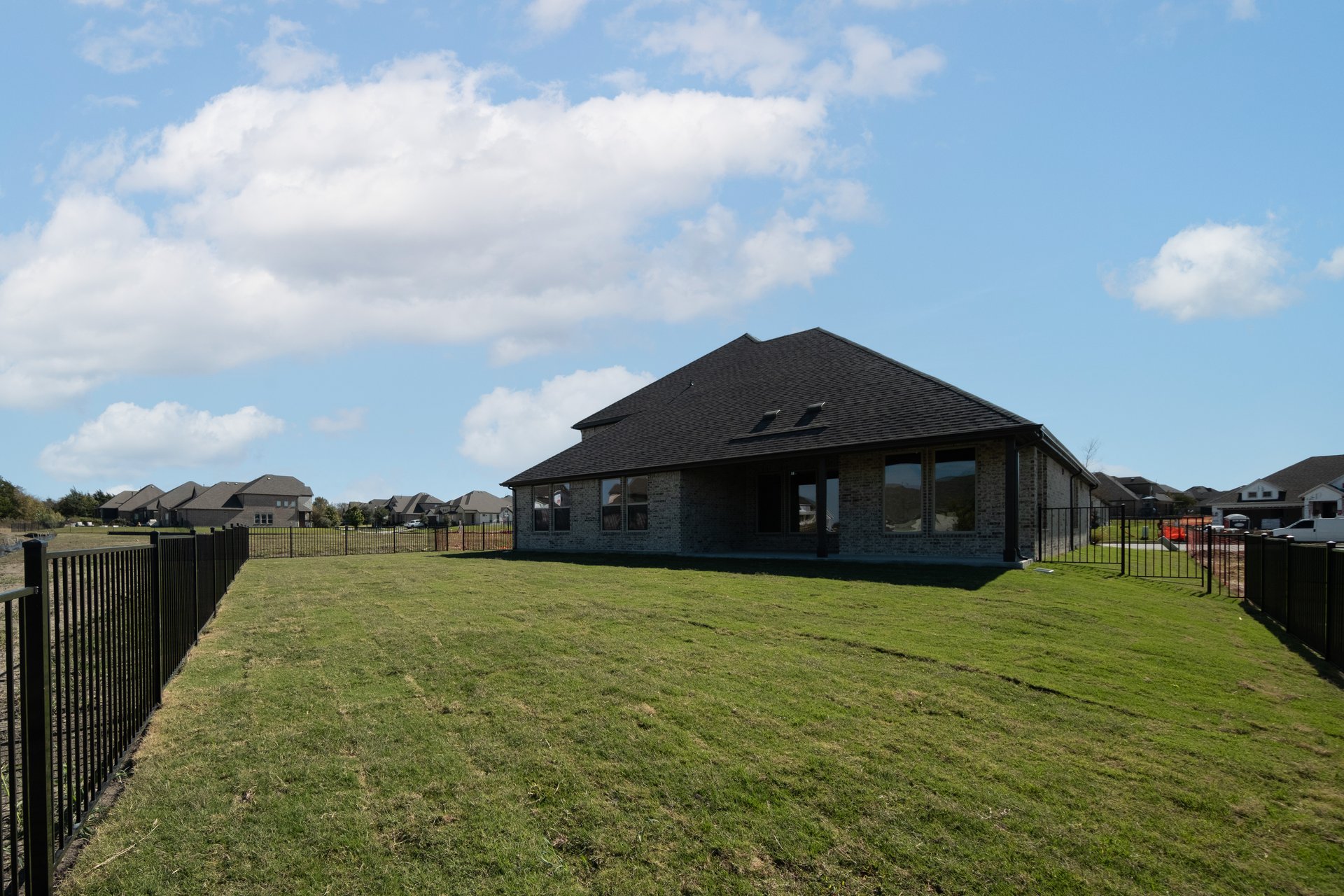 large backyard with fence and grass
