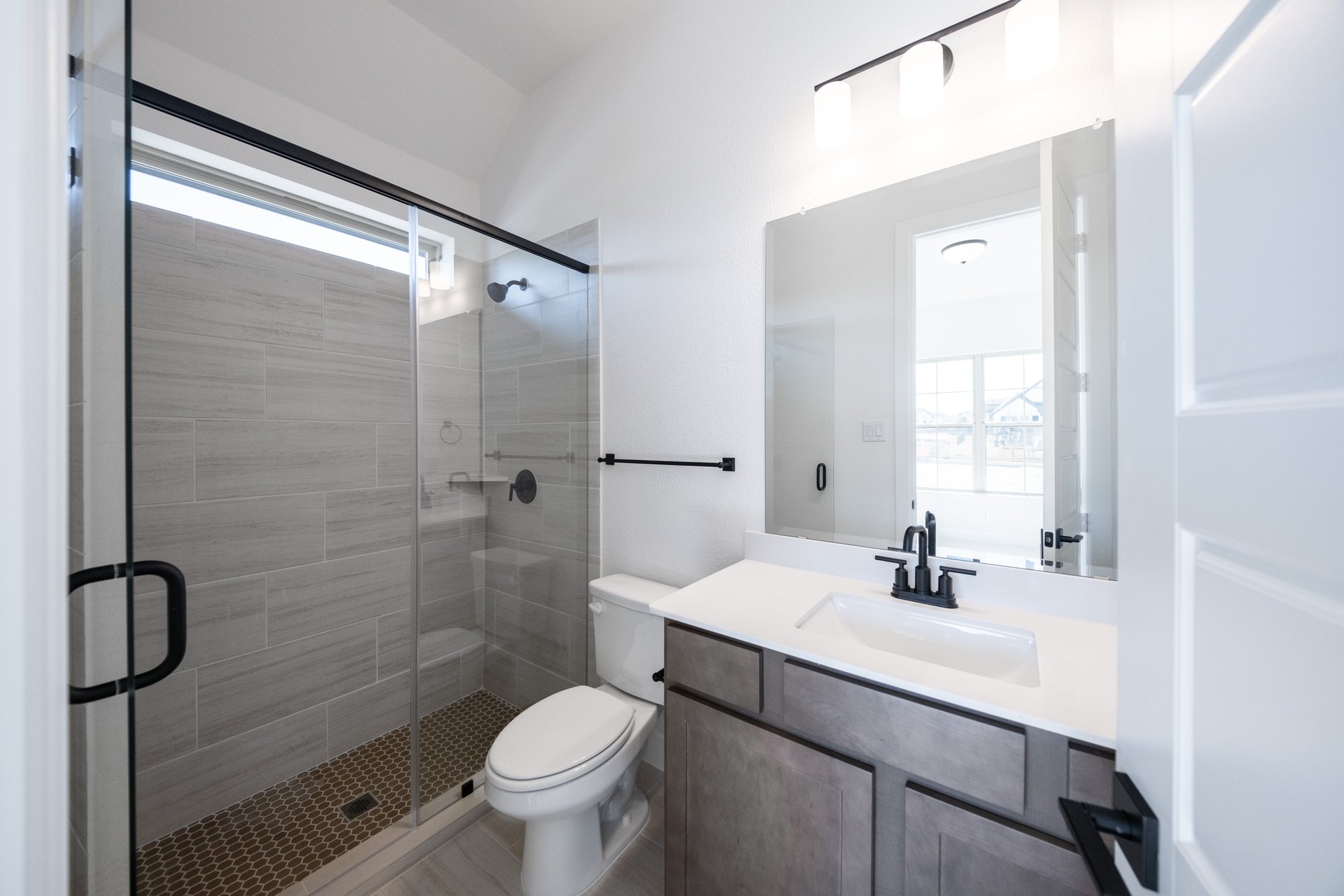bathroom with walk-in shower and tile