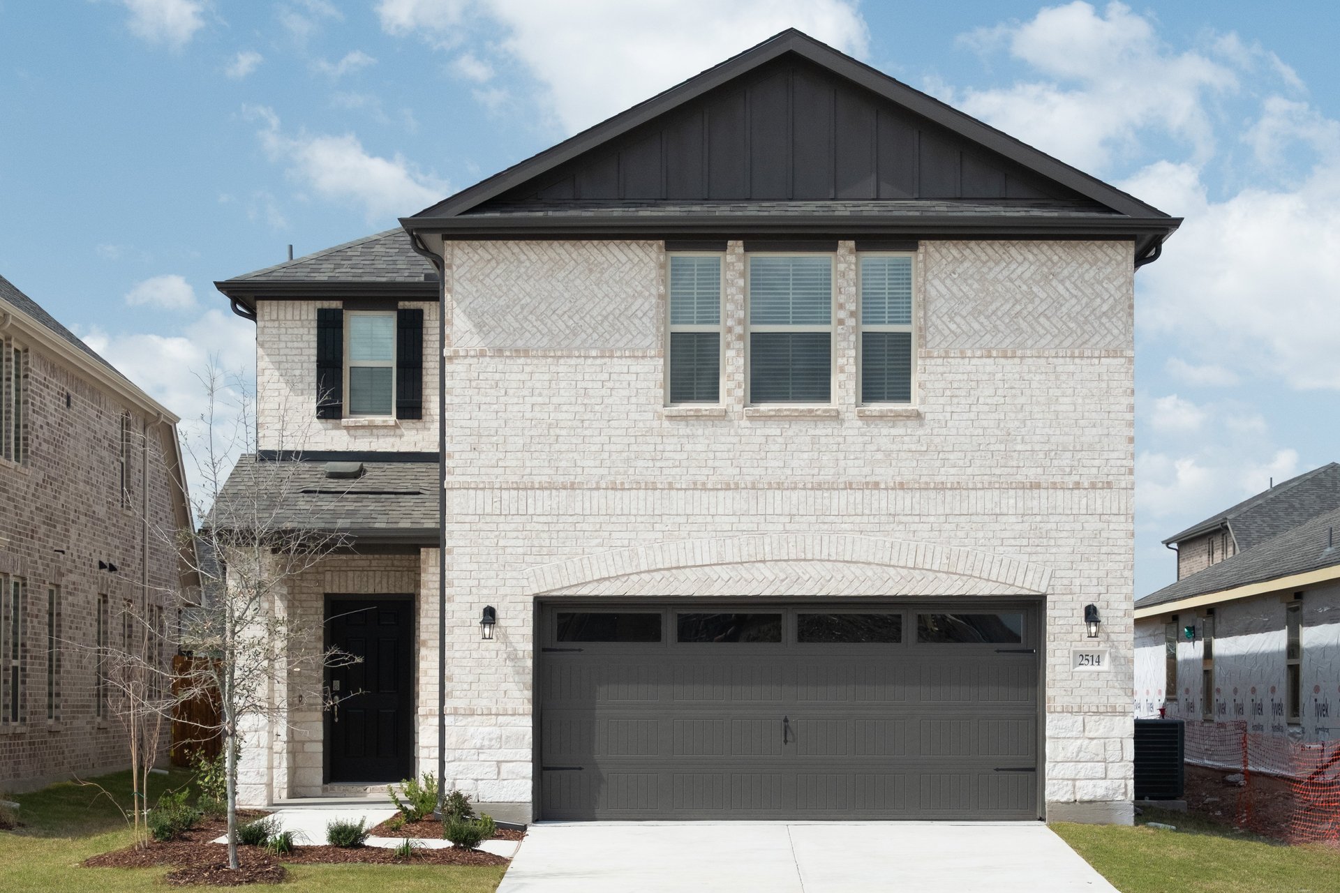 exterior of home with white brick and black siding