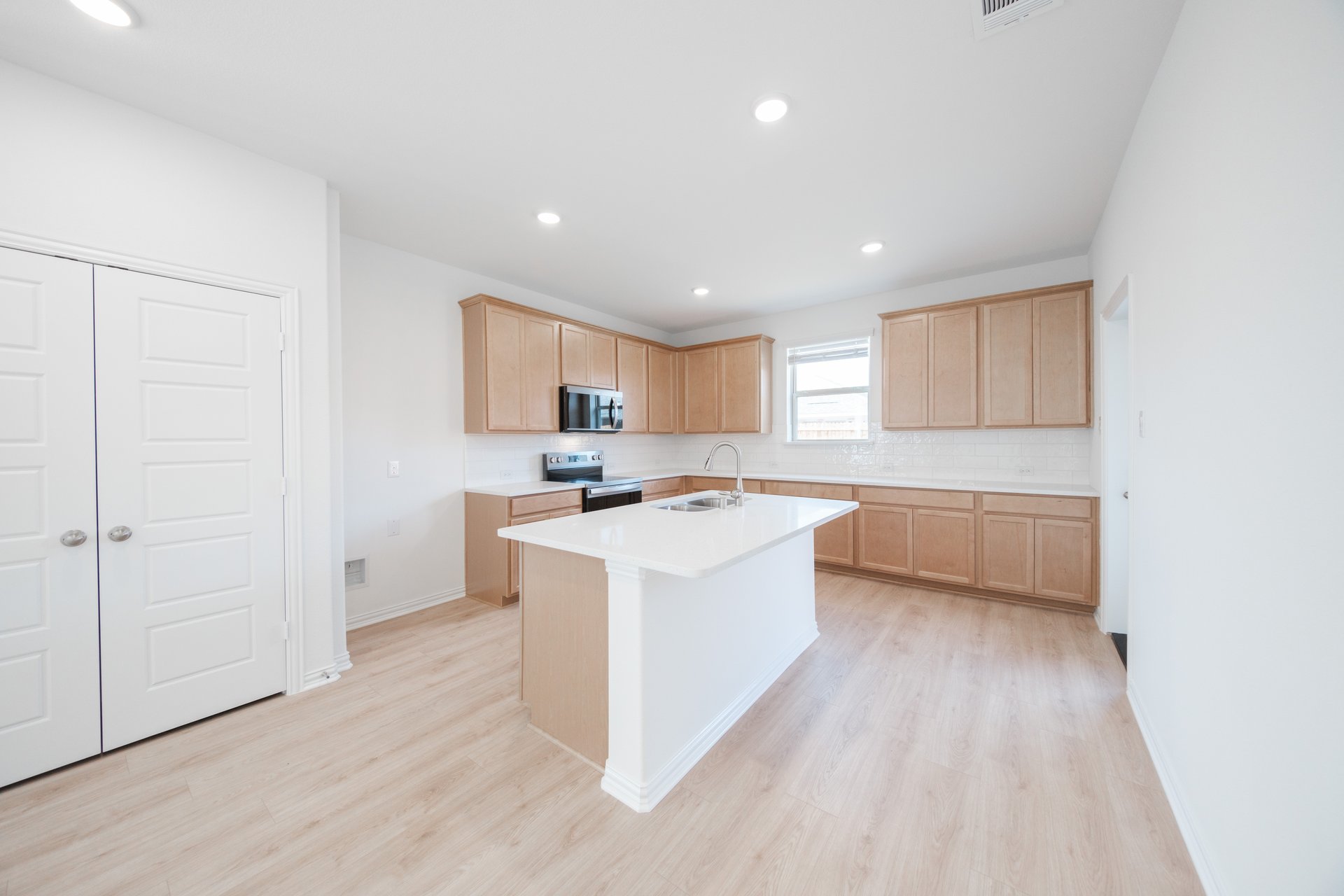 open kitchen with brown cabinets and white countertops