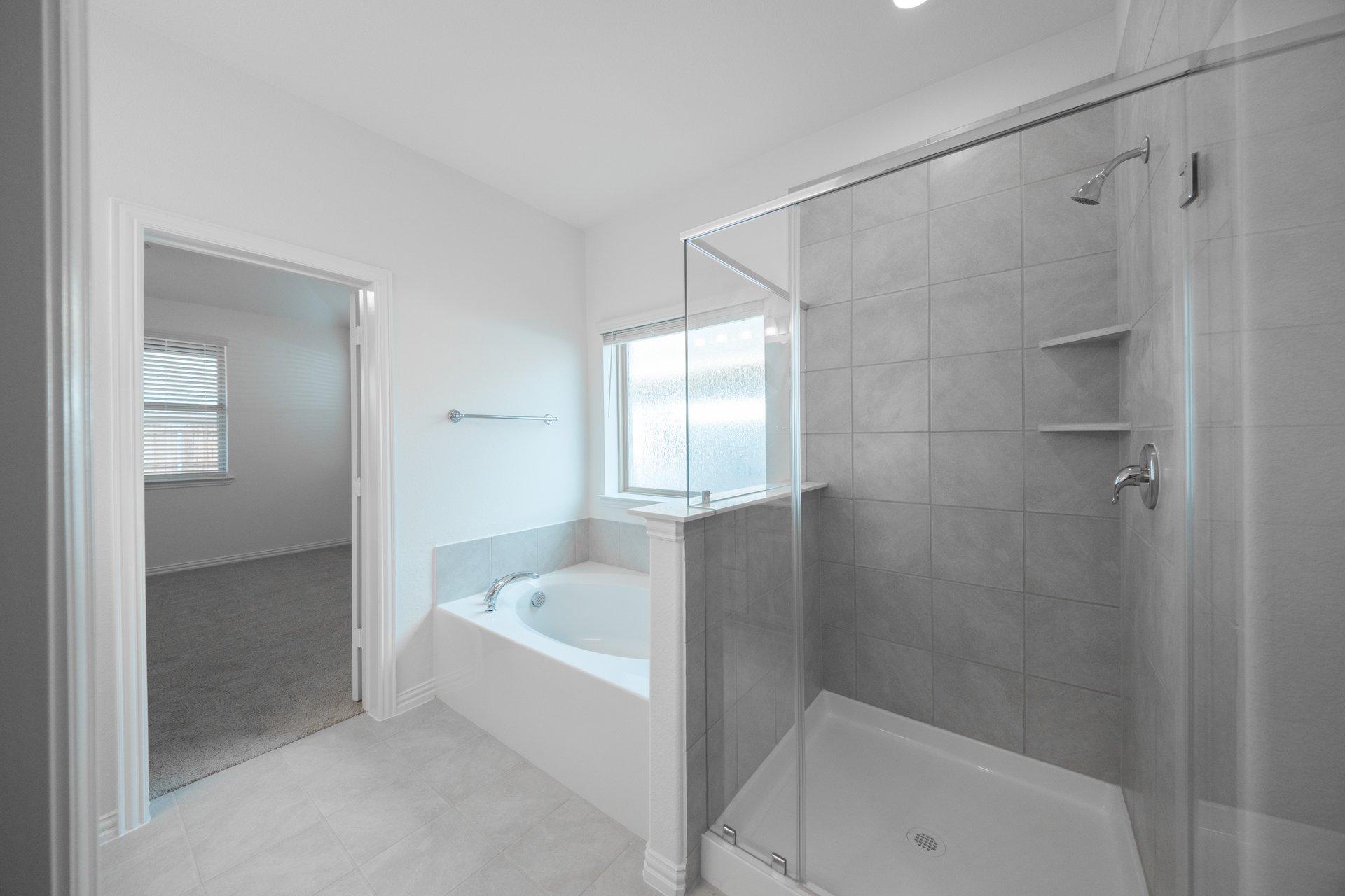 primary bathroom with separate soaking tub and walk-in shower