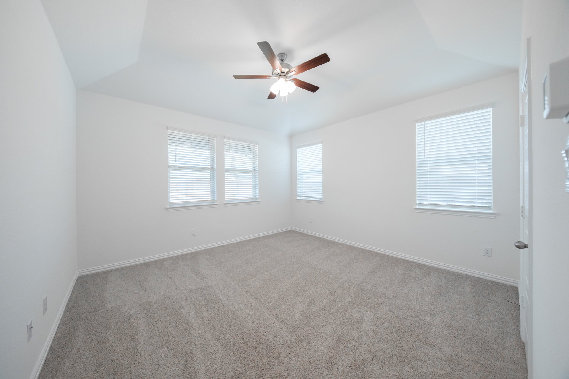 spacious primary bedroom with ceiling fan