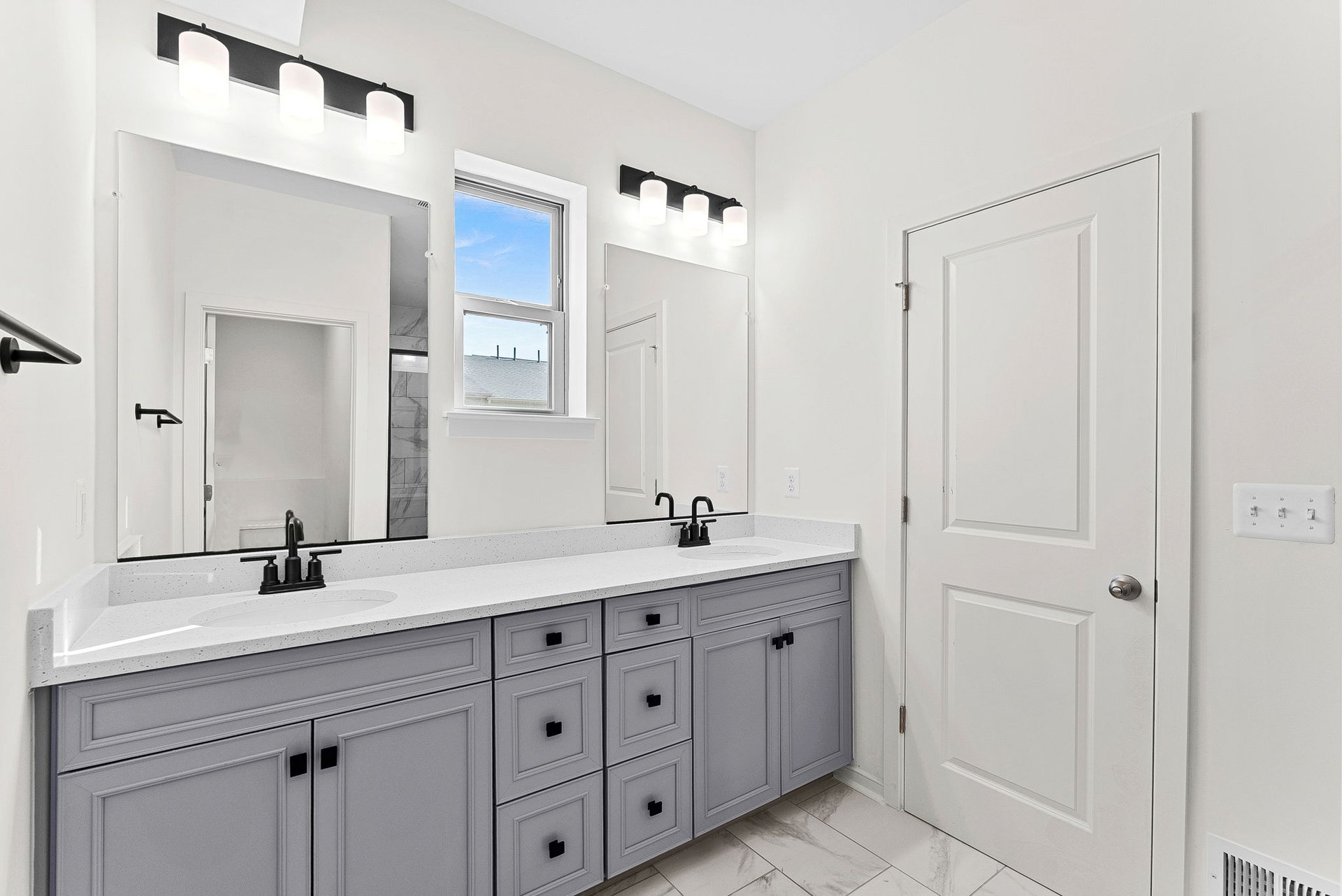 primary bathroom with two sinks and an oversized shower