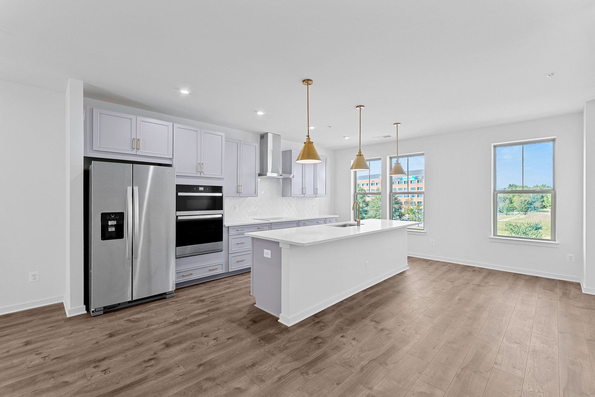 kitchen with an island with a sink and pendant lighting