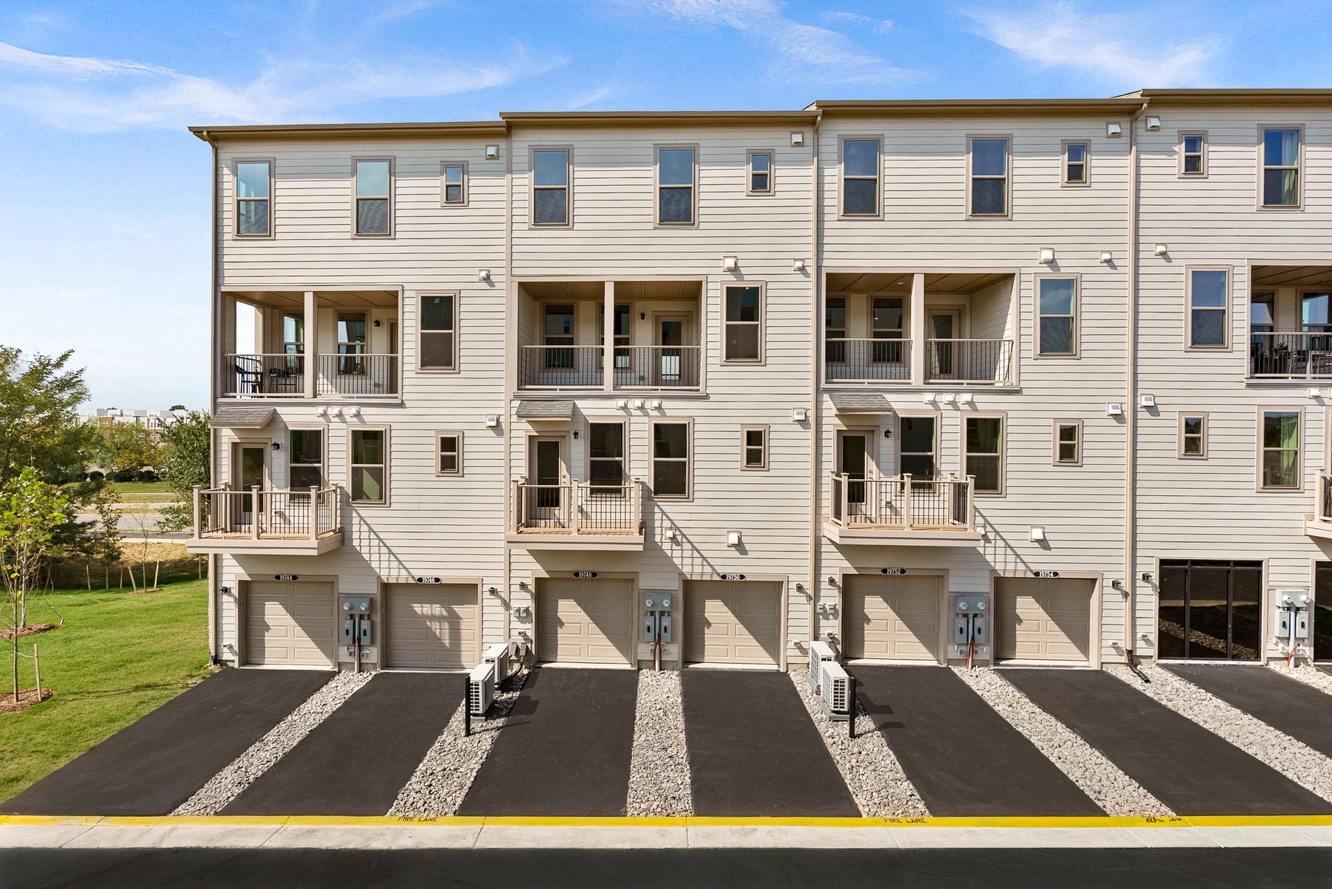 rear exterior of home with a deck and a garage