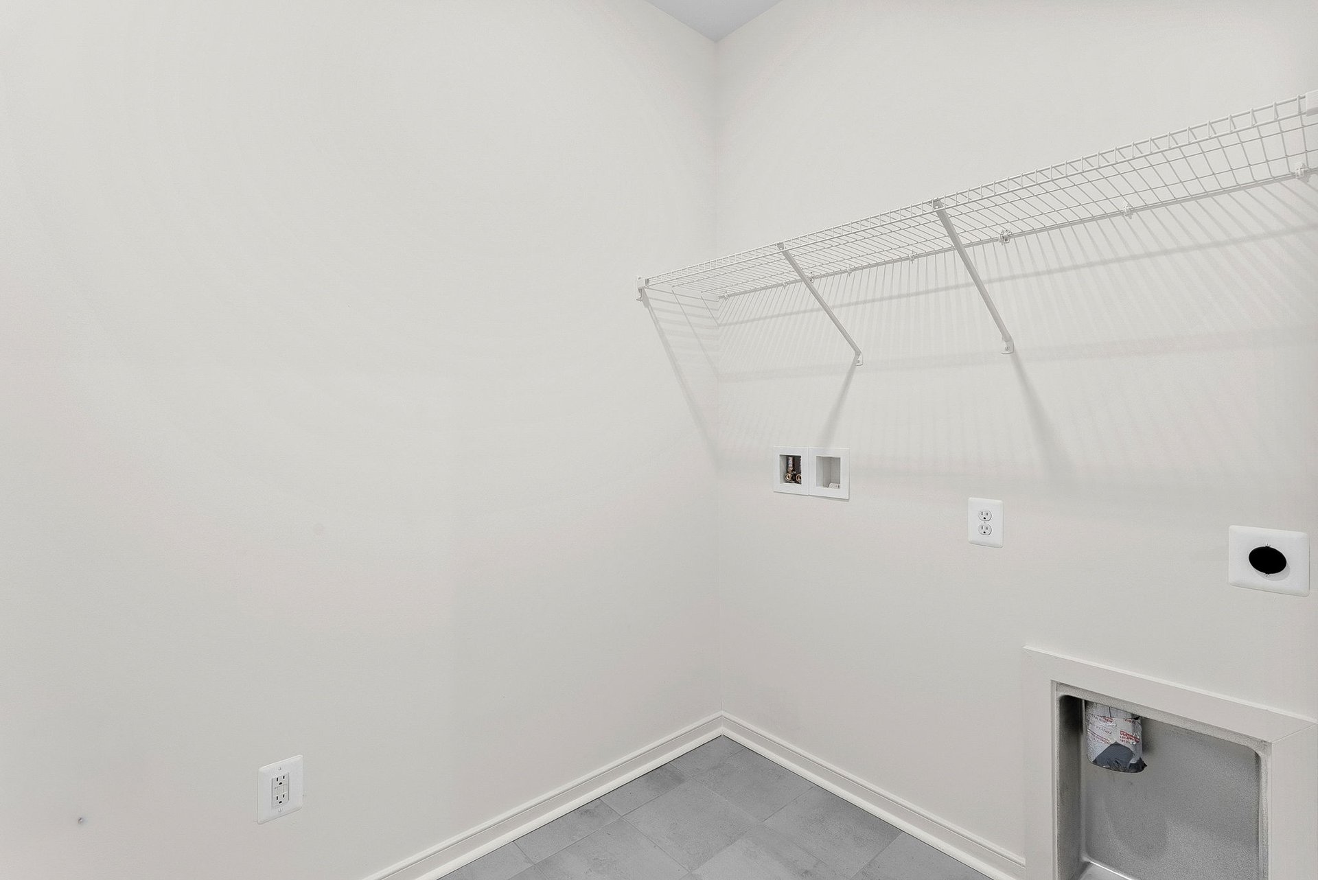 walk-in closet with white rack on top