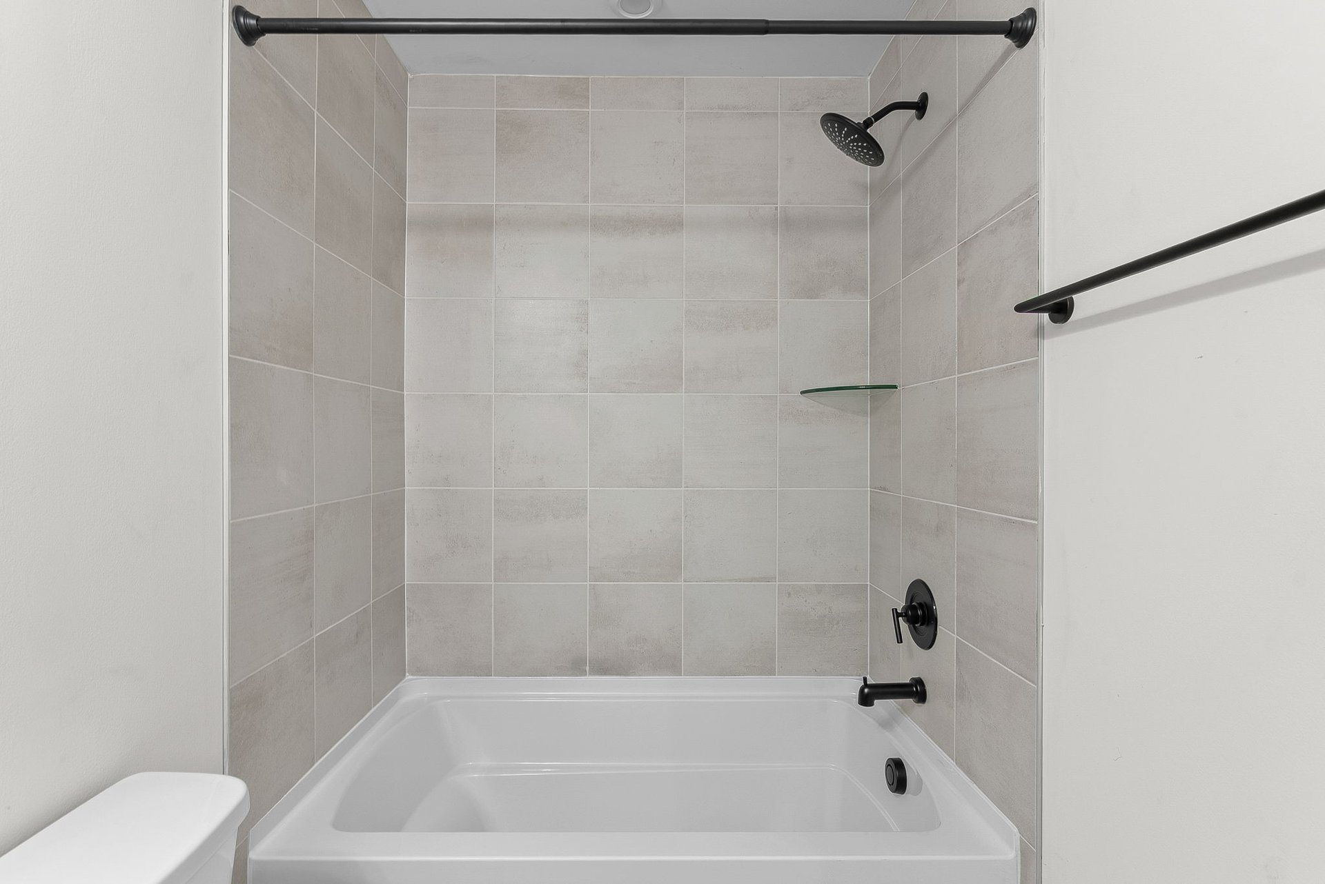 secondary bathroom with separate tub and shower